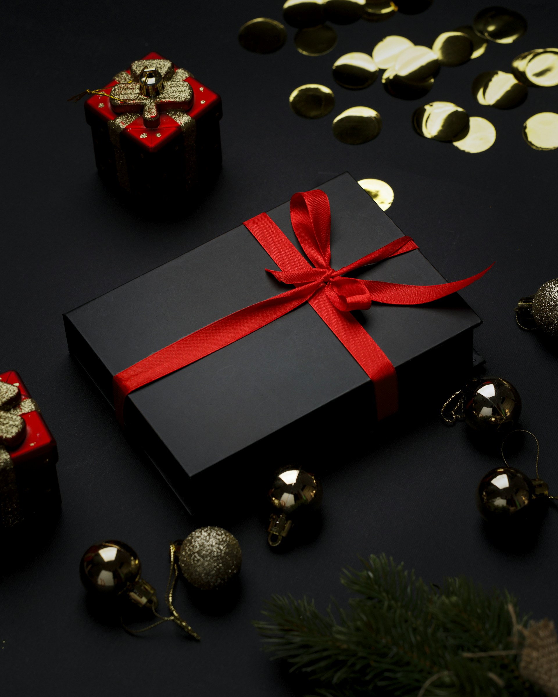 A black box with a red ribbon and bells