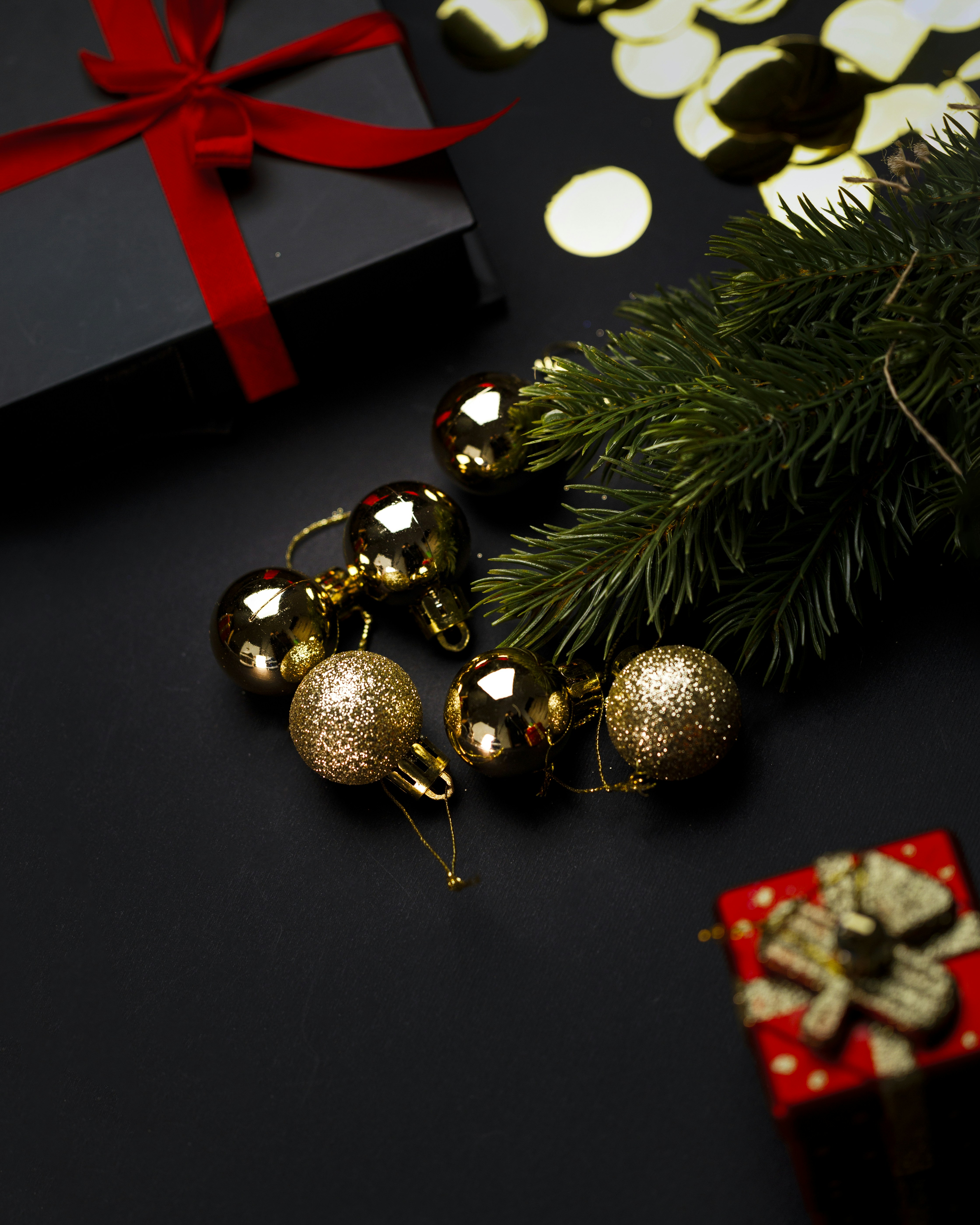 A christmas tree with presents and a red bow