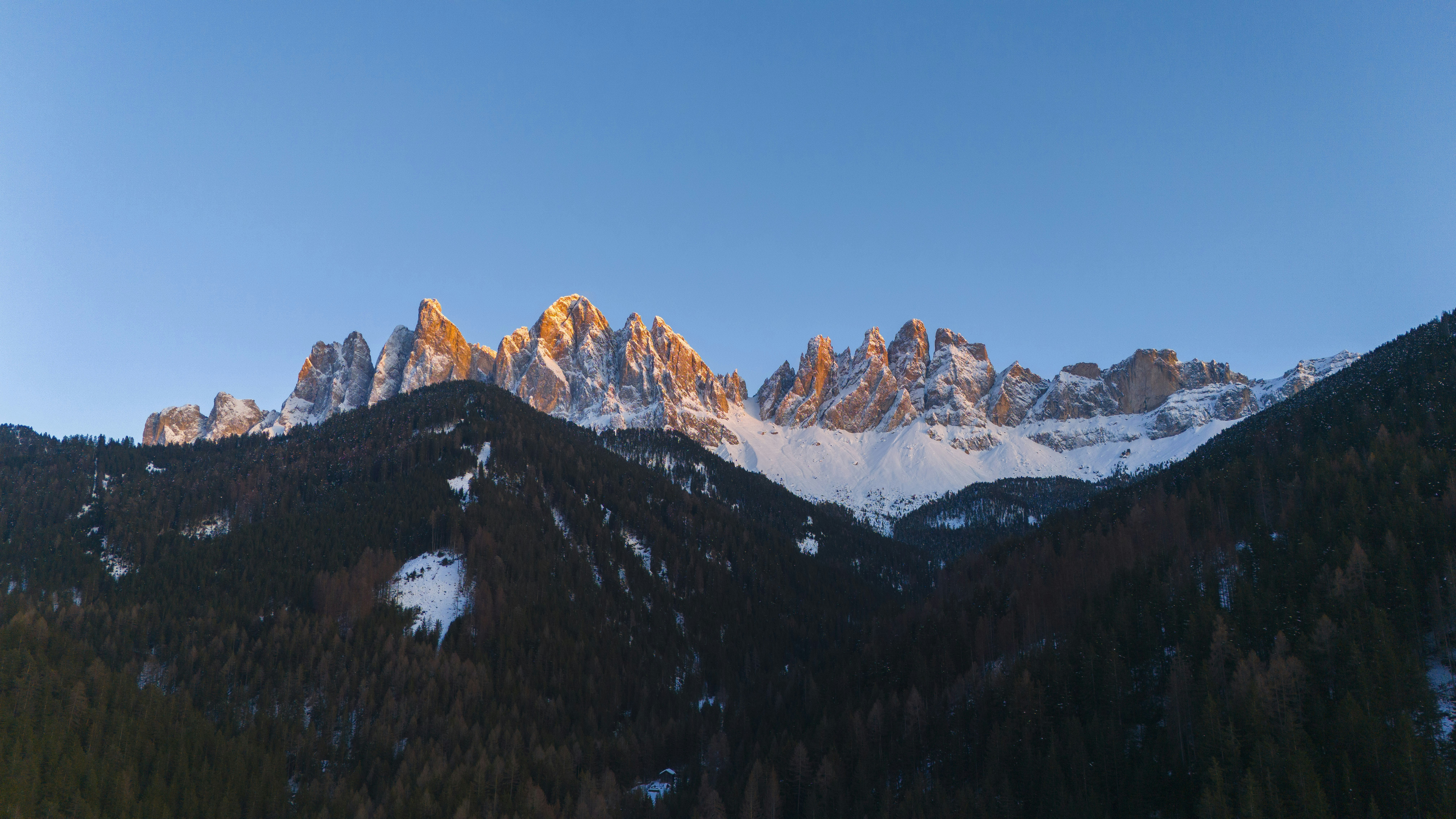 A view of a mountain range with snow on it