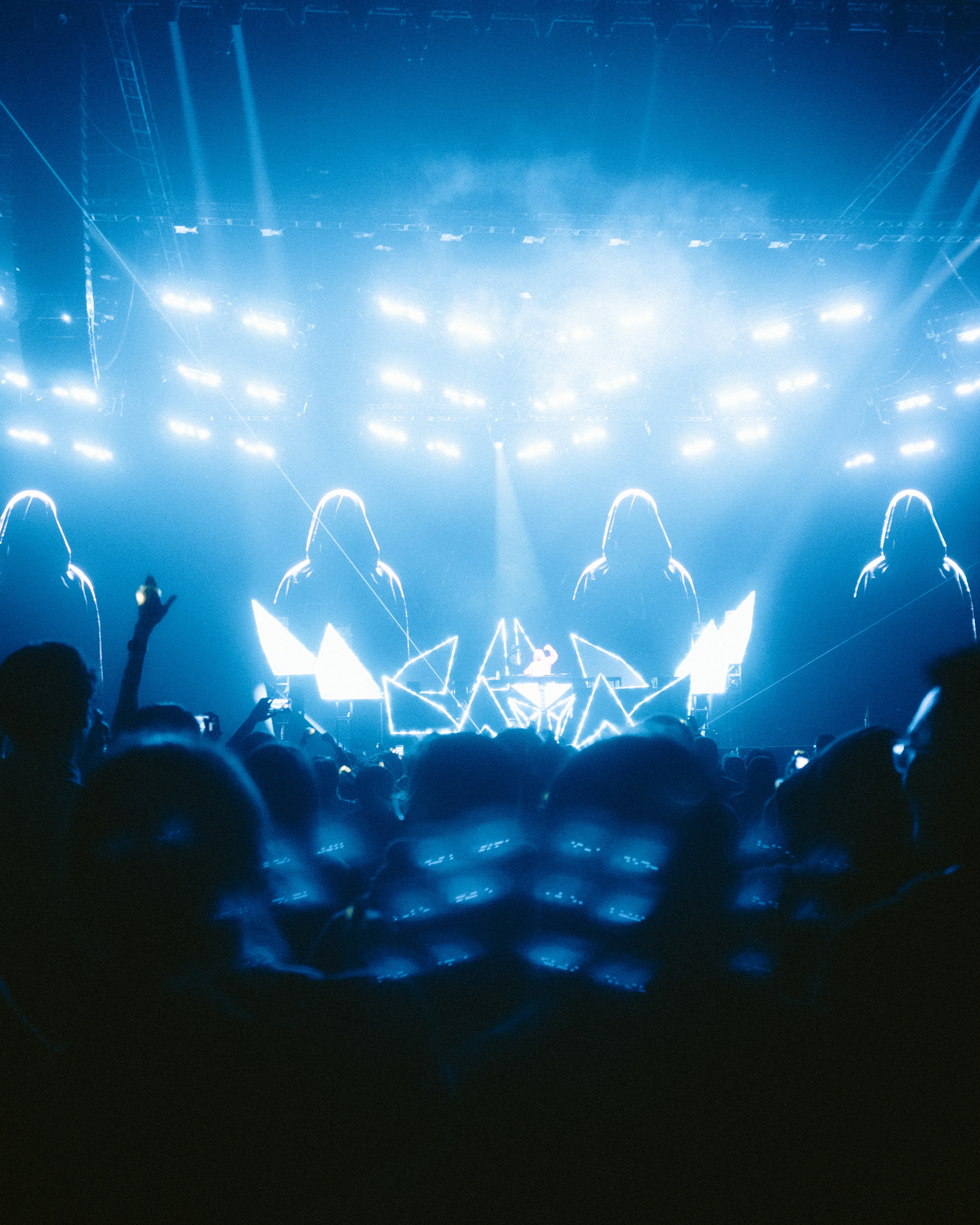 A crowd of people sitting in front of a stage