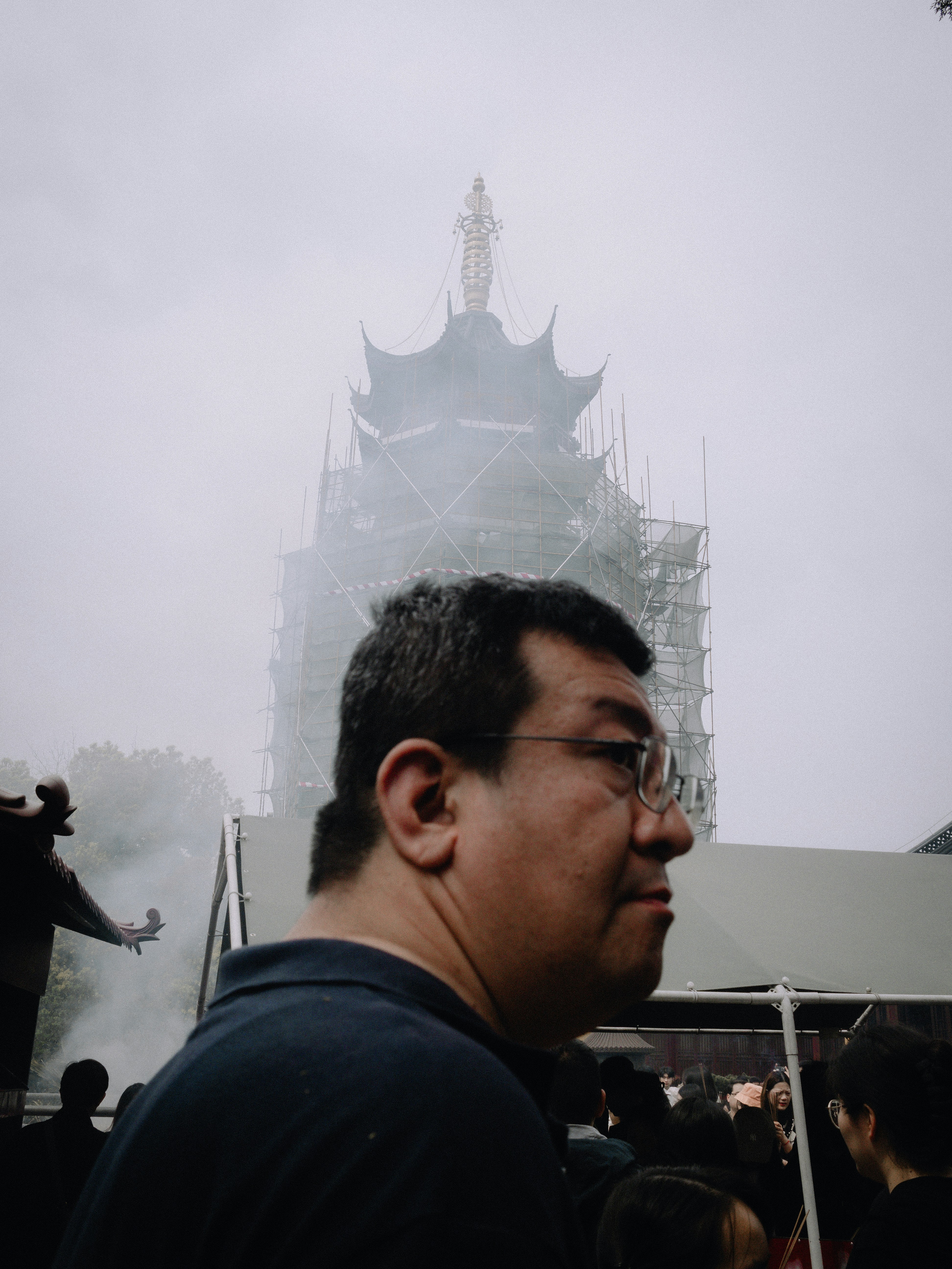A man standing in front of a tall building