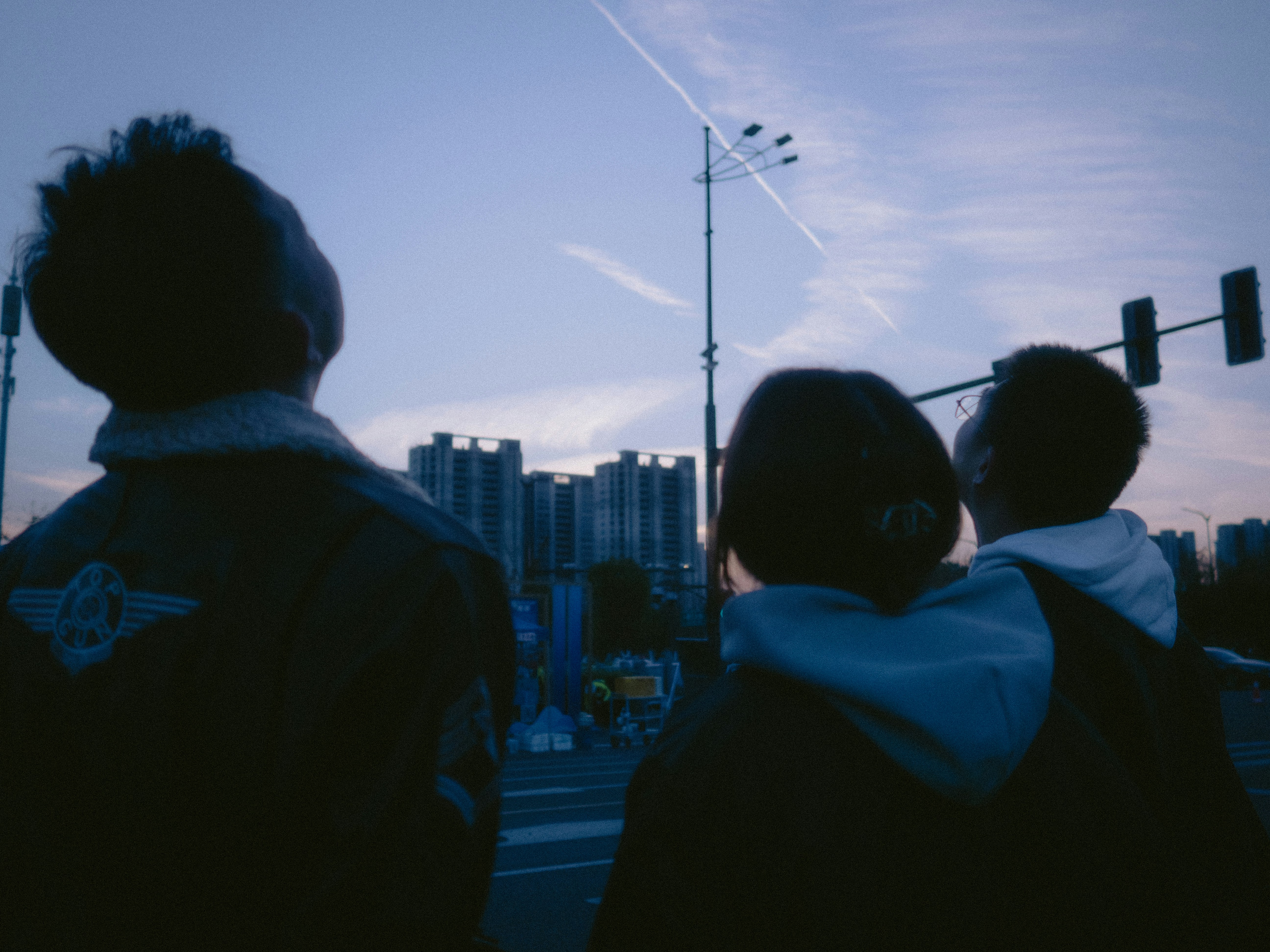 A couple of people that are standing in the street