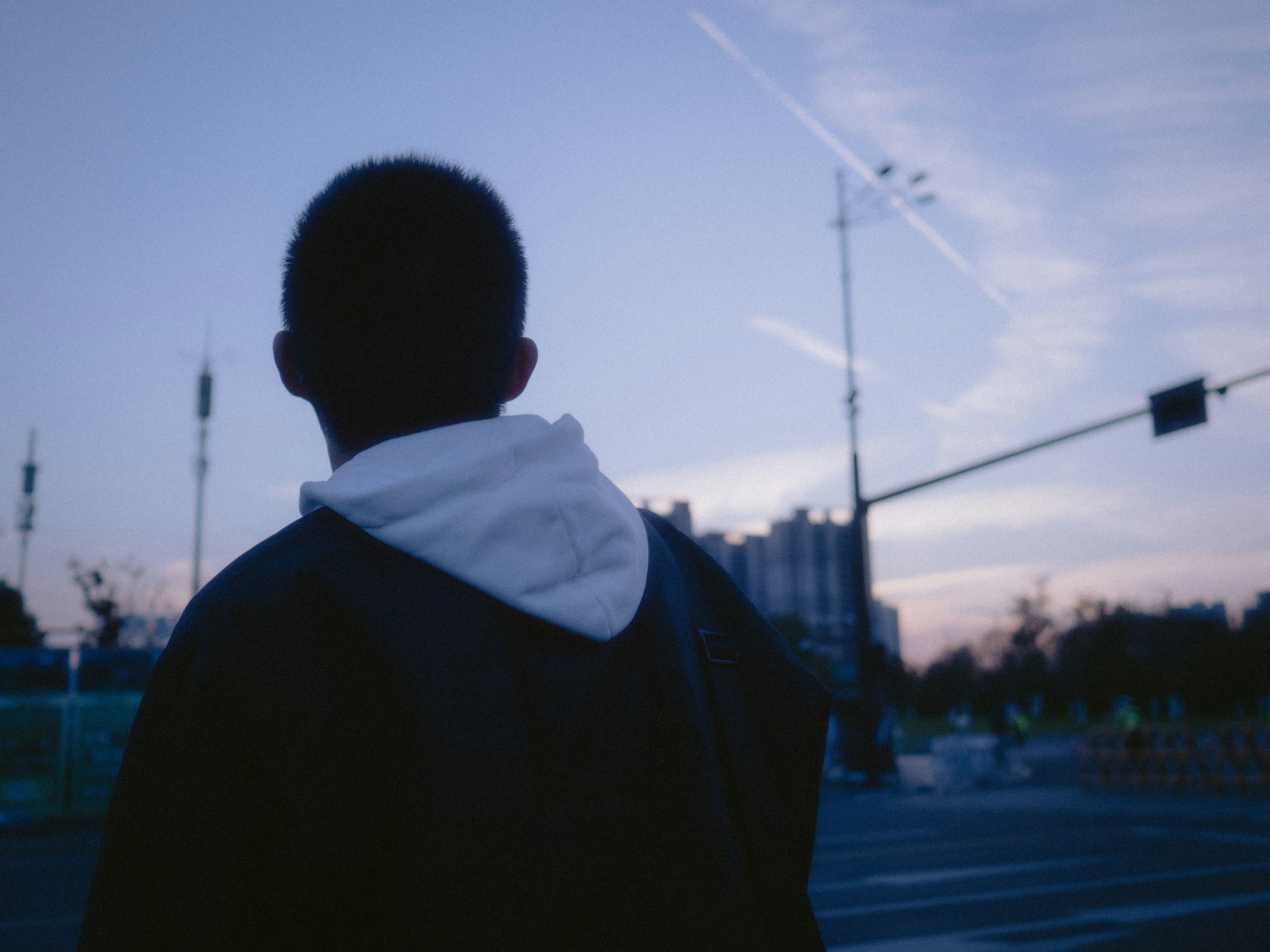 A man standing on the side of a road