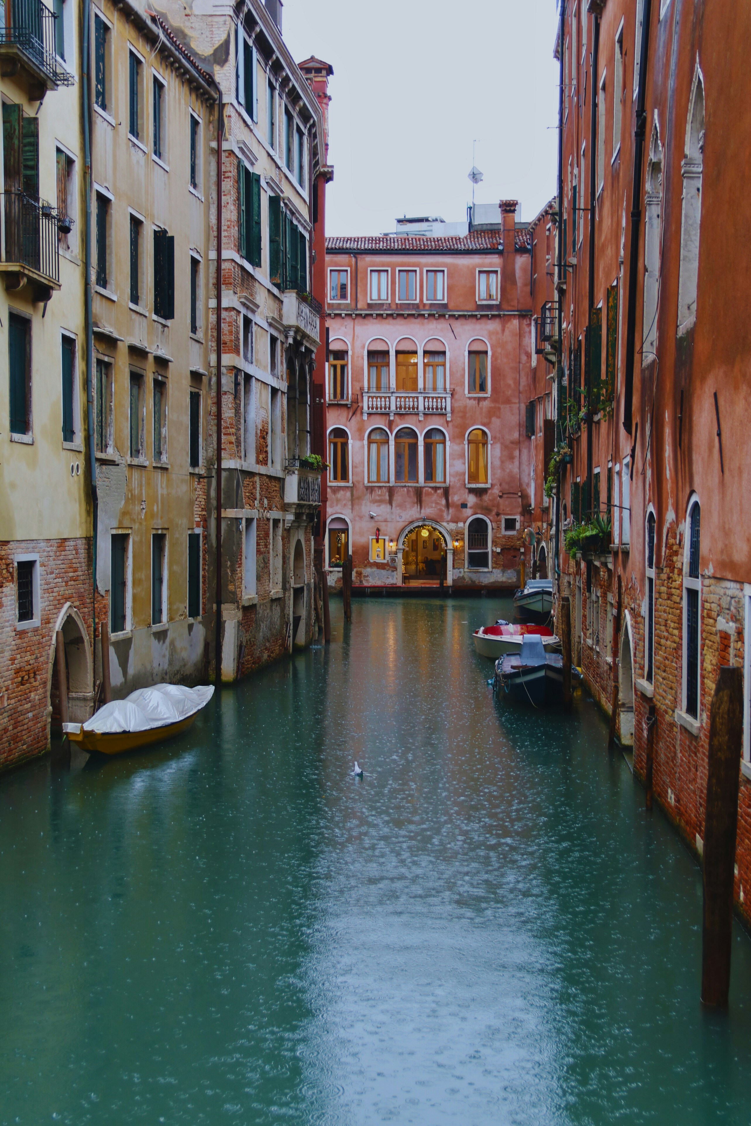 A narrow canal in a city with buildings on both sides