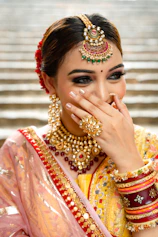 A woman in a yellow and red bridal outfit