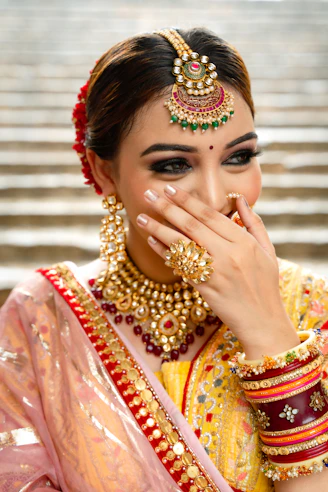 A woman in a yellow and red bridal outfit