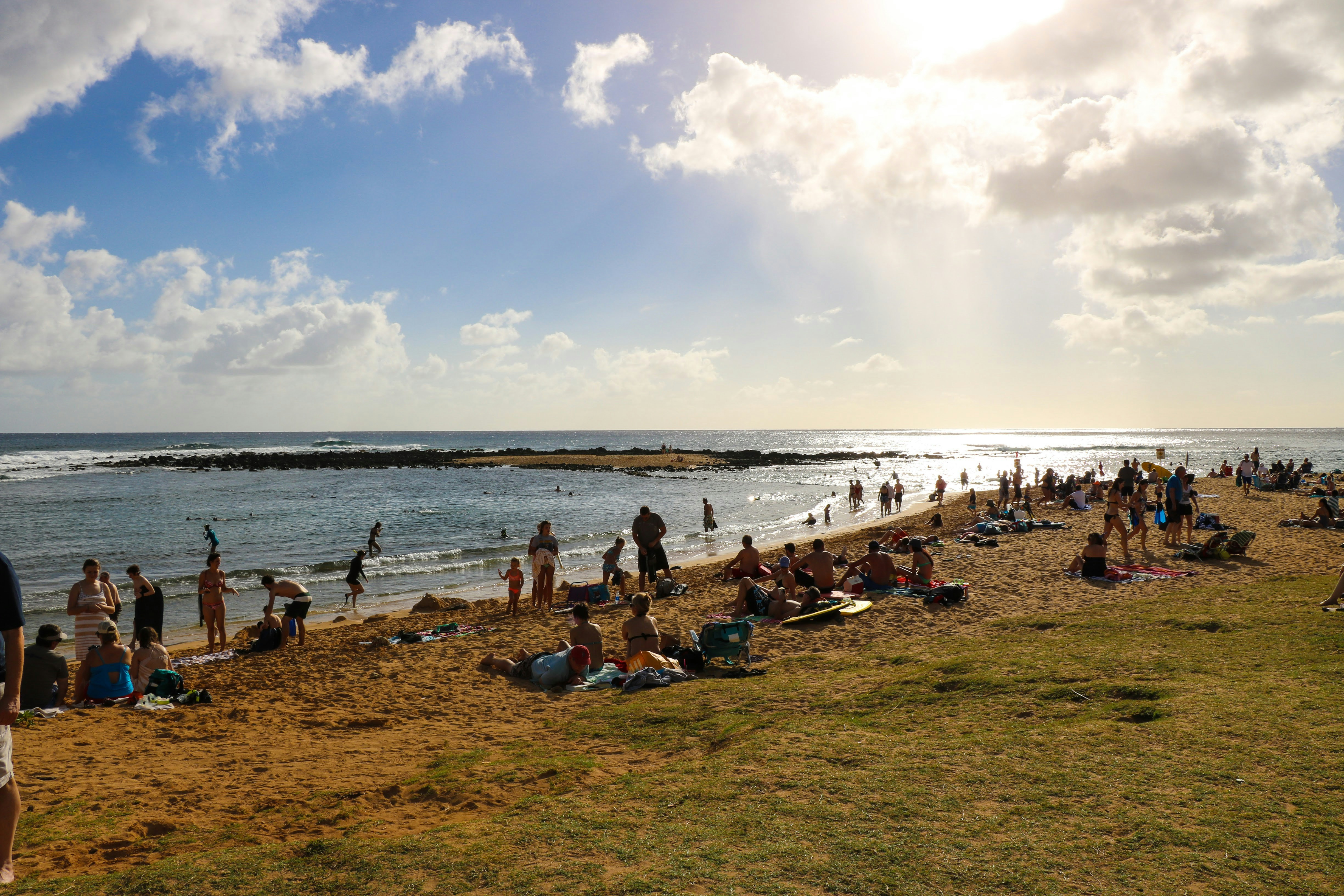 A group of people standing on top of a sandy beach