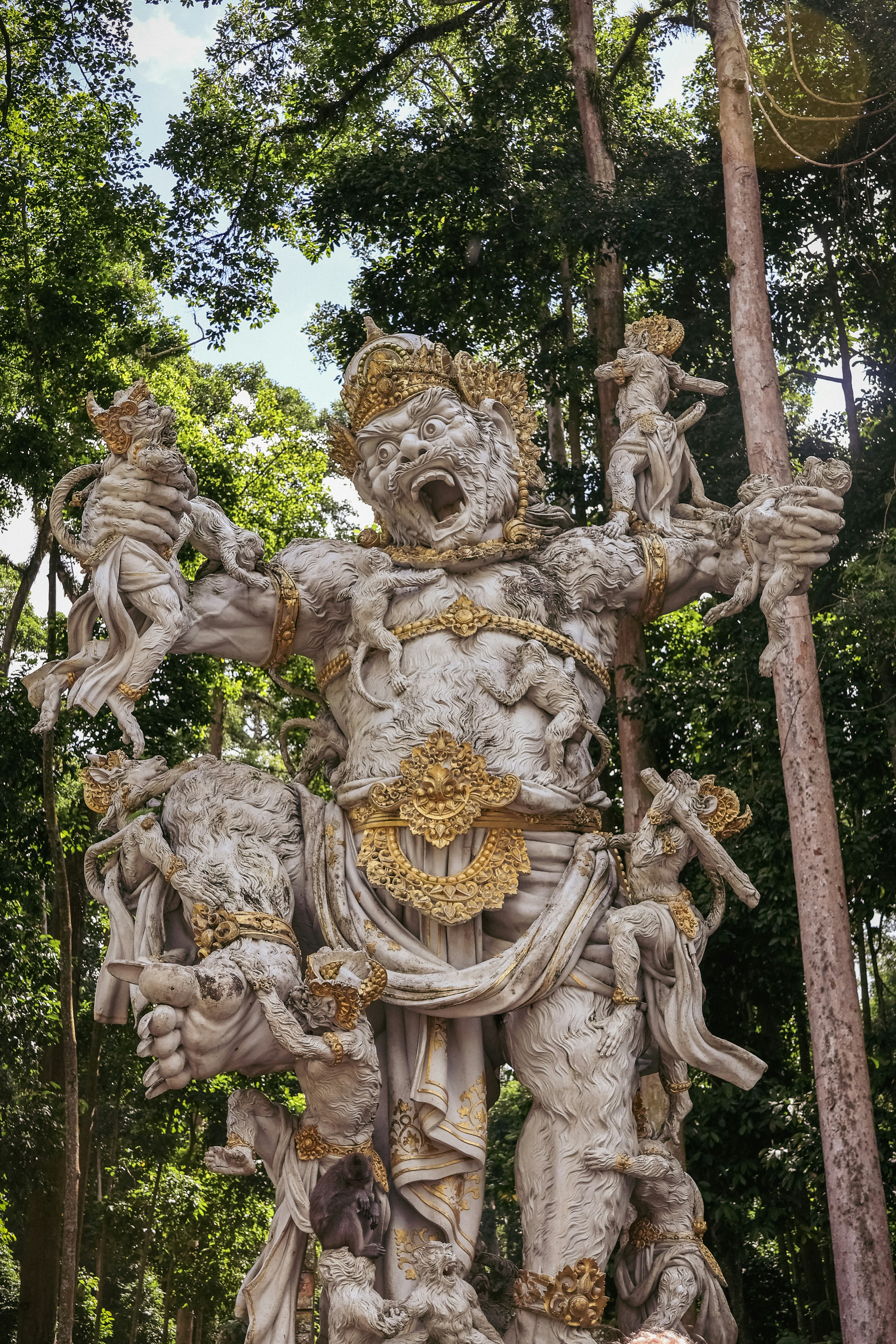 A statue of a god in a forest