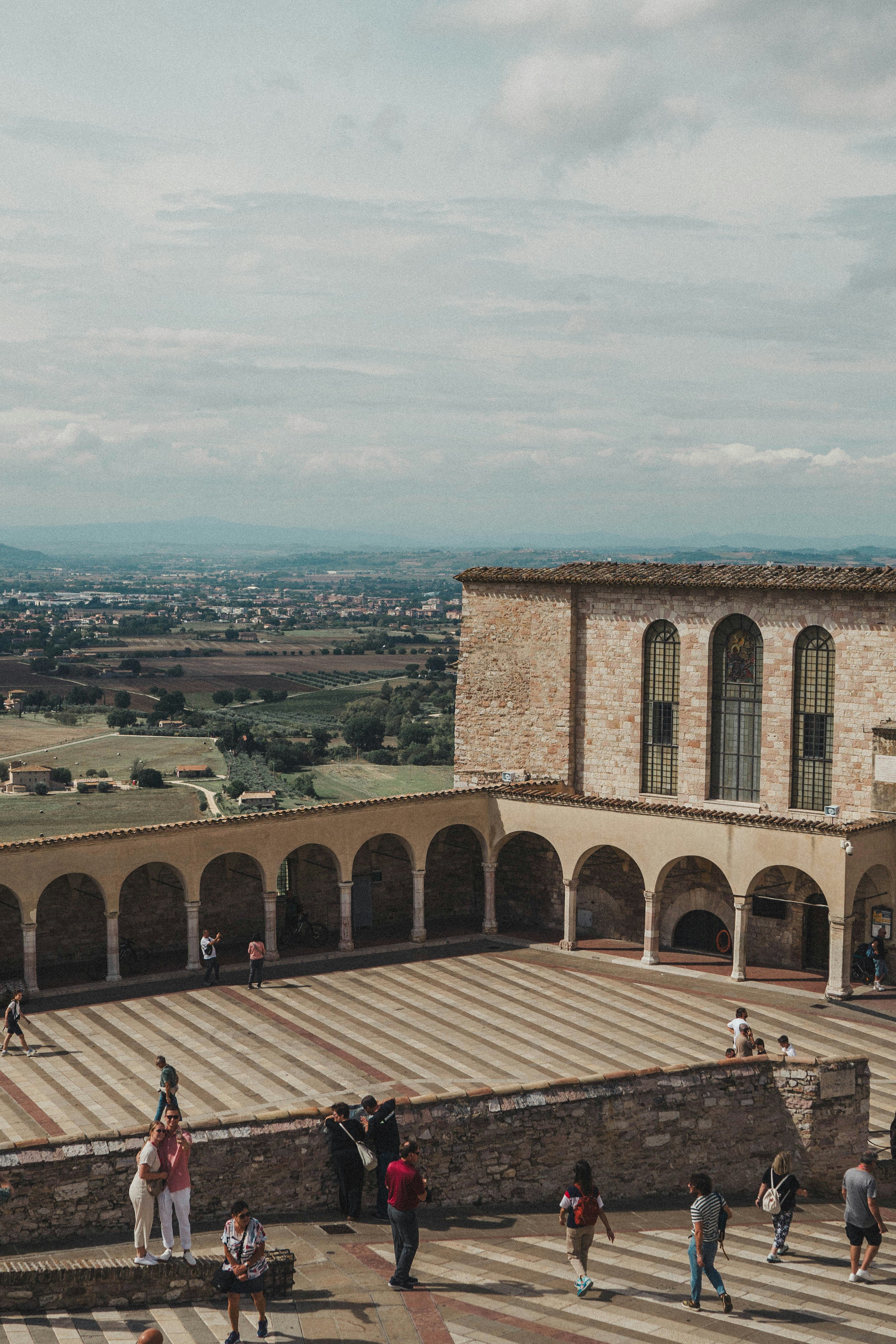 A group of people standing on top of a stone building