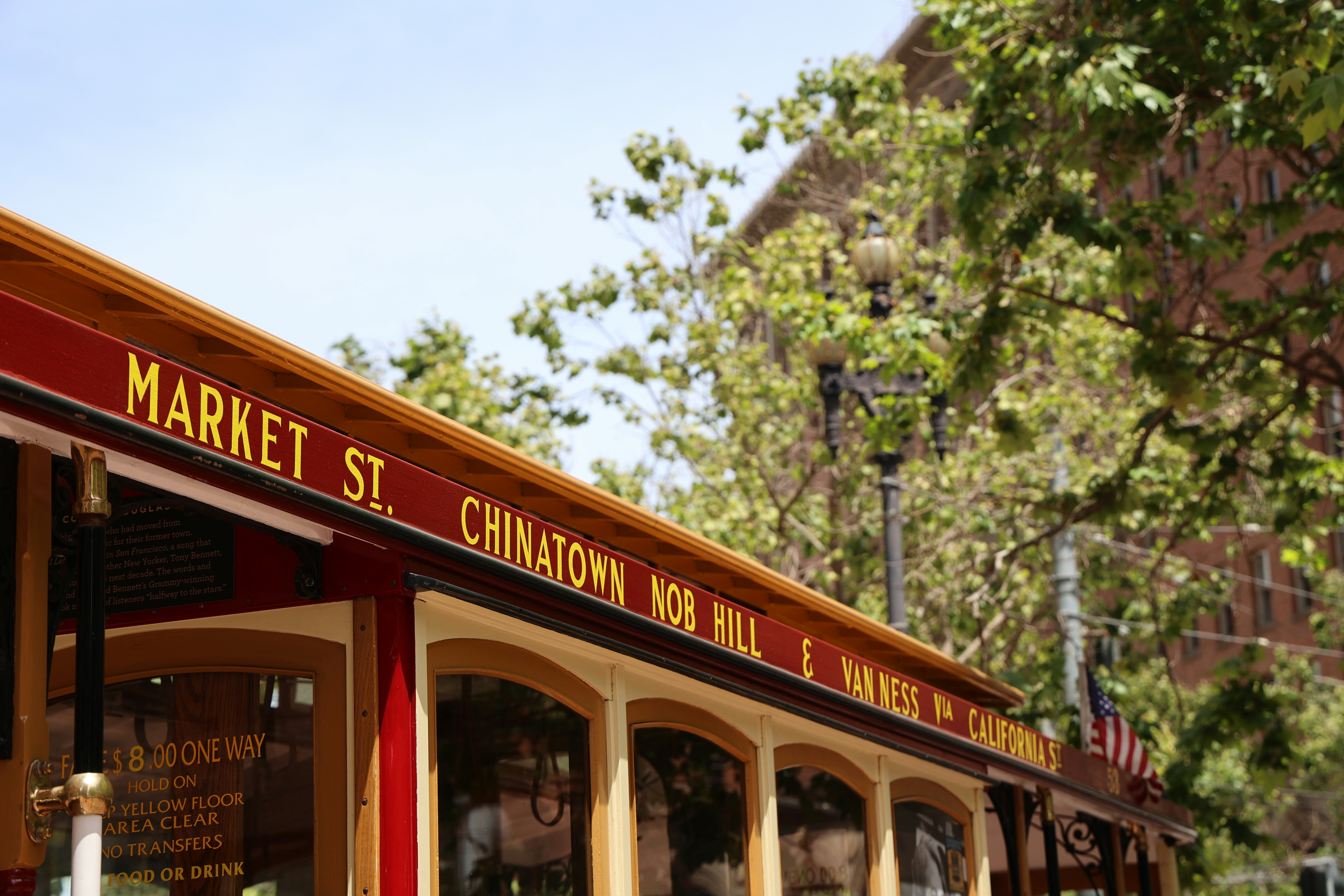 A red and yellow bus parked in front of a building
