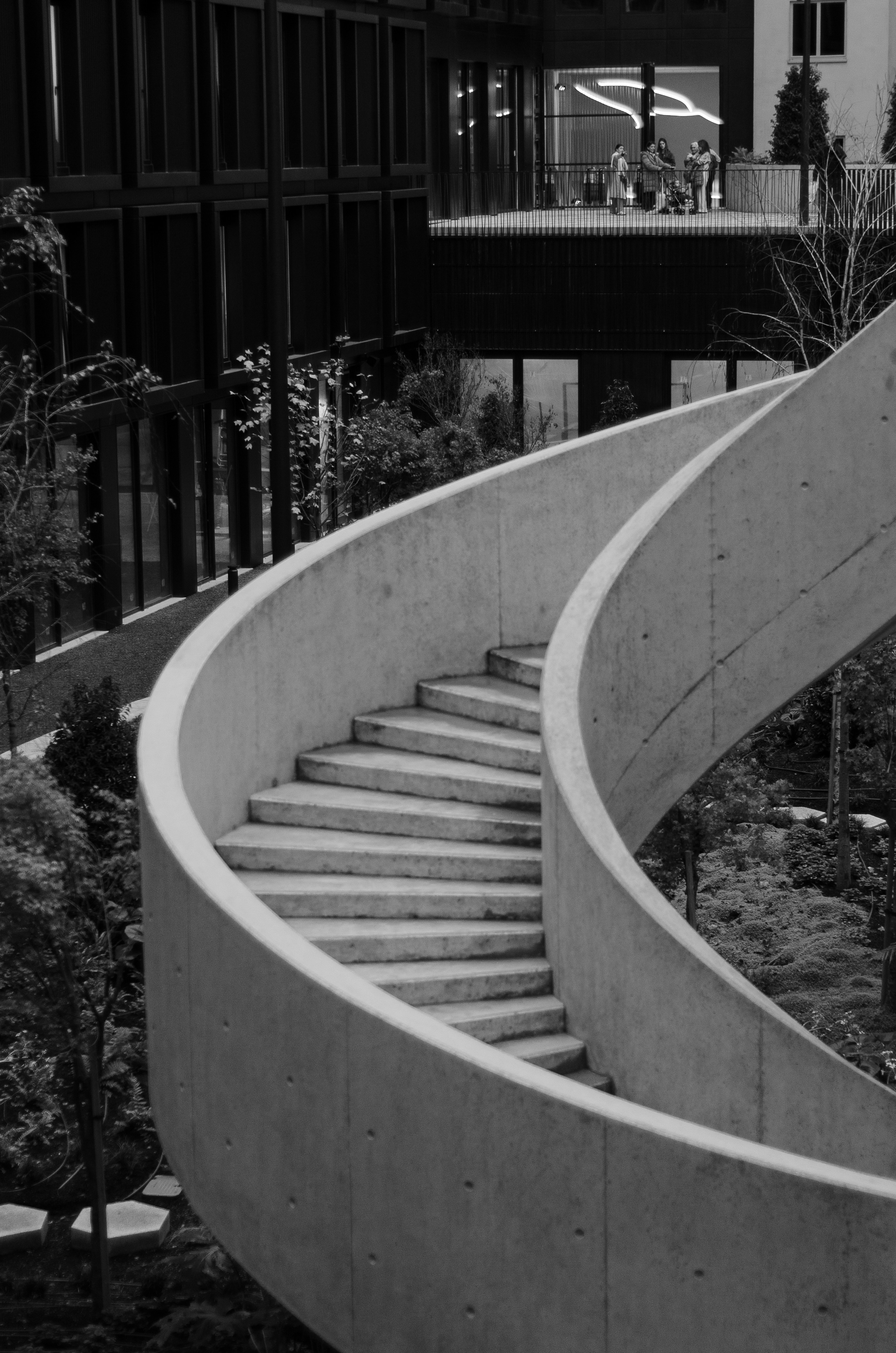 A black and white photo of a spiral staircase
