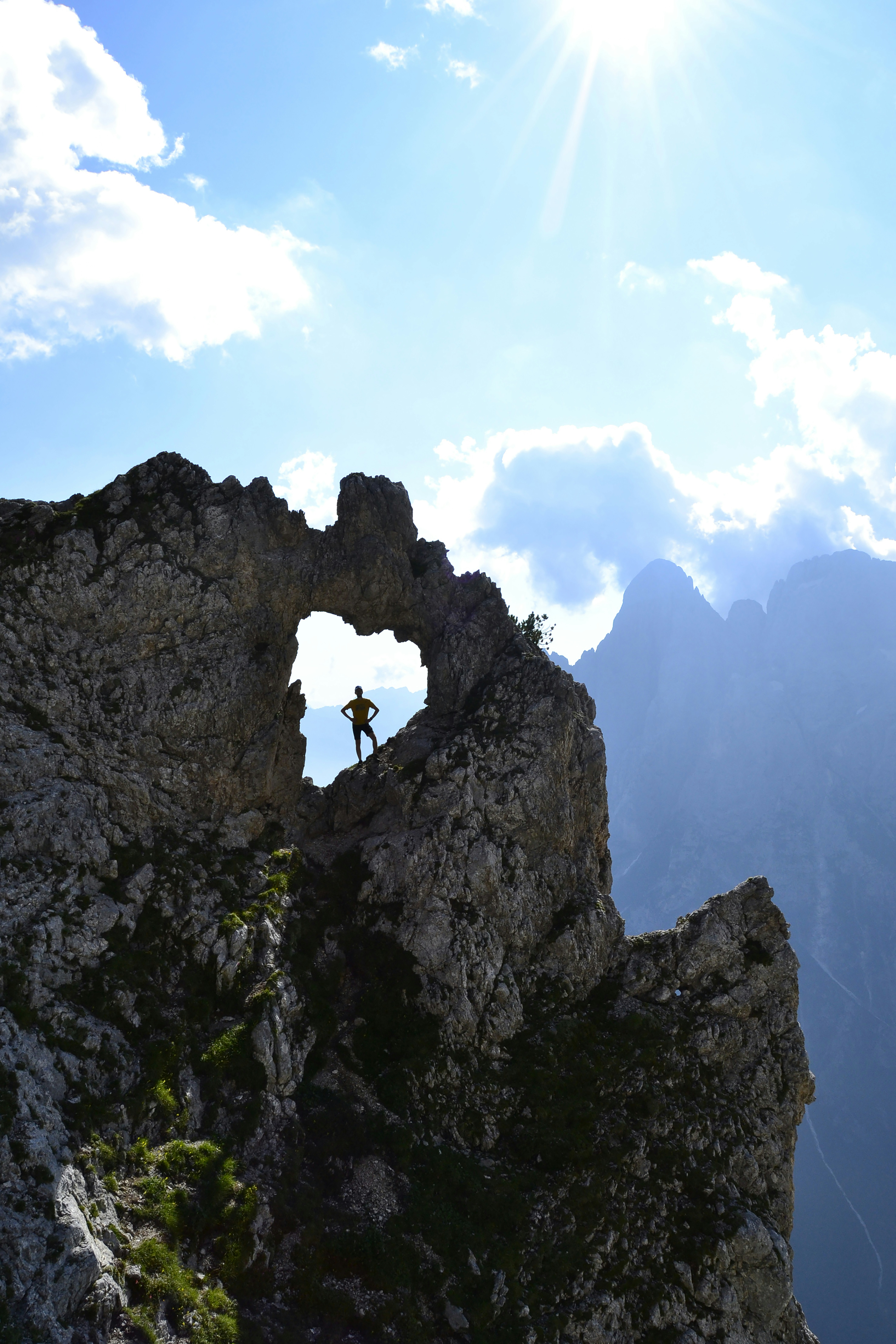 A person standing on top of a rocky mountain
