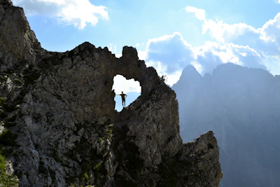 A man standing on top of a rocky mountain