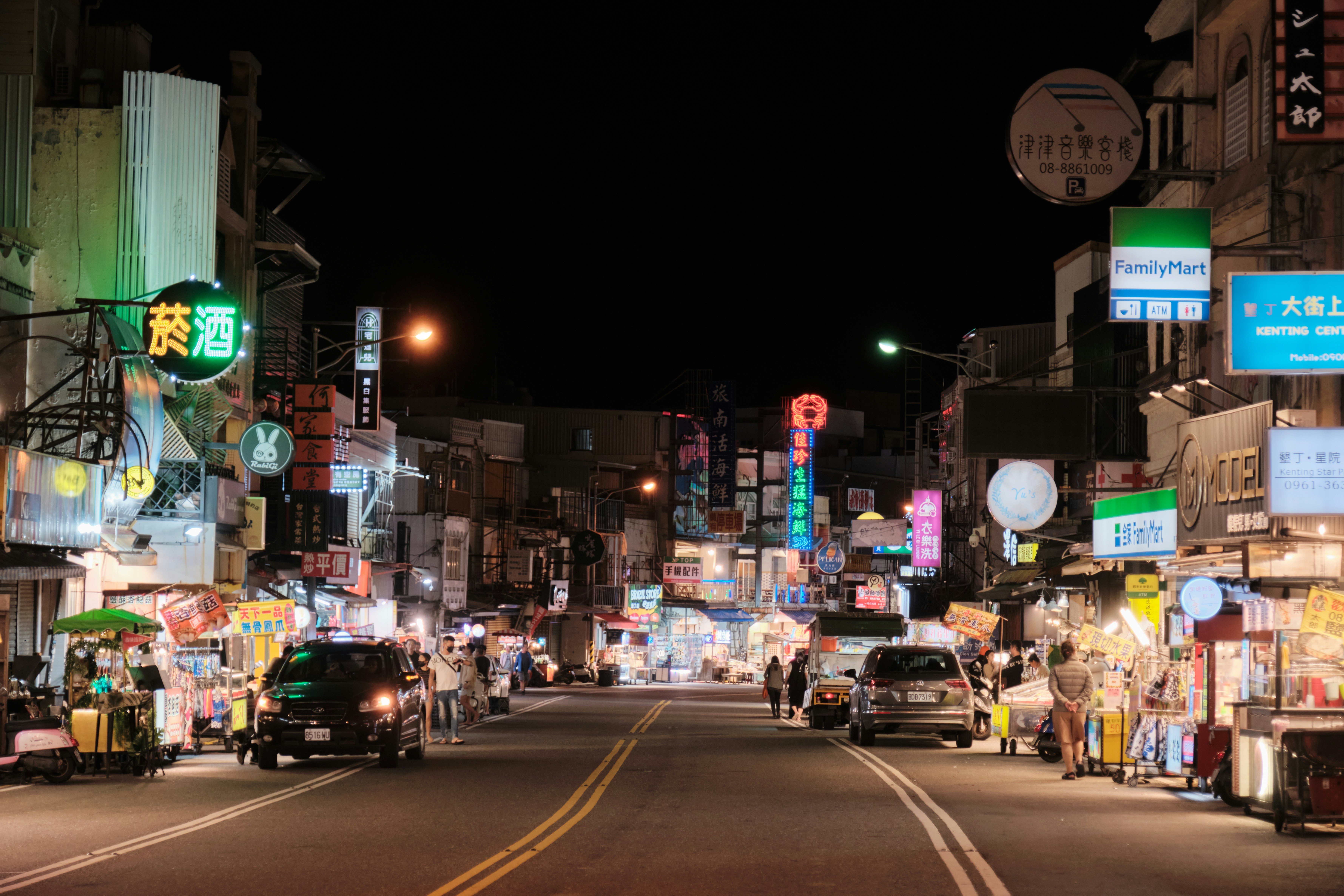 A city street at night filled with traffic