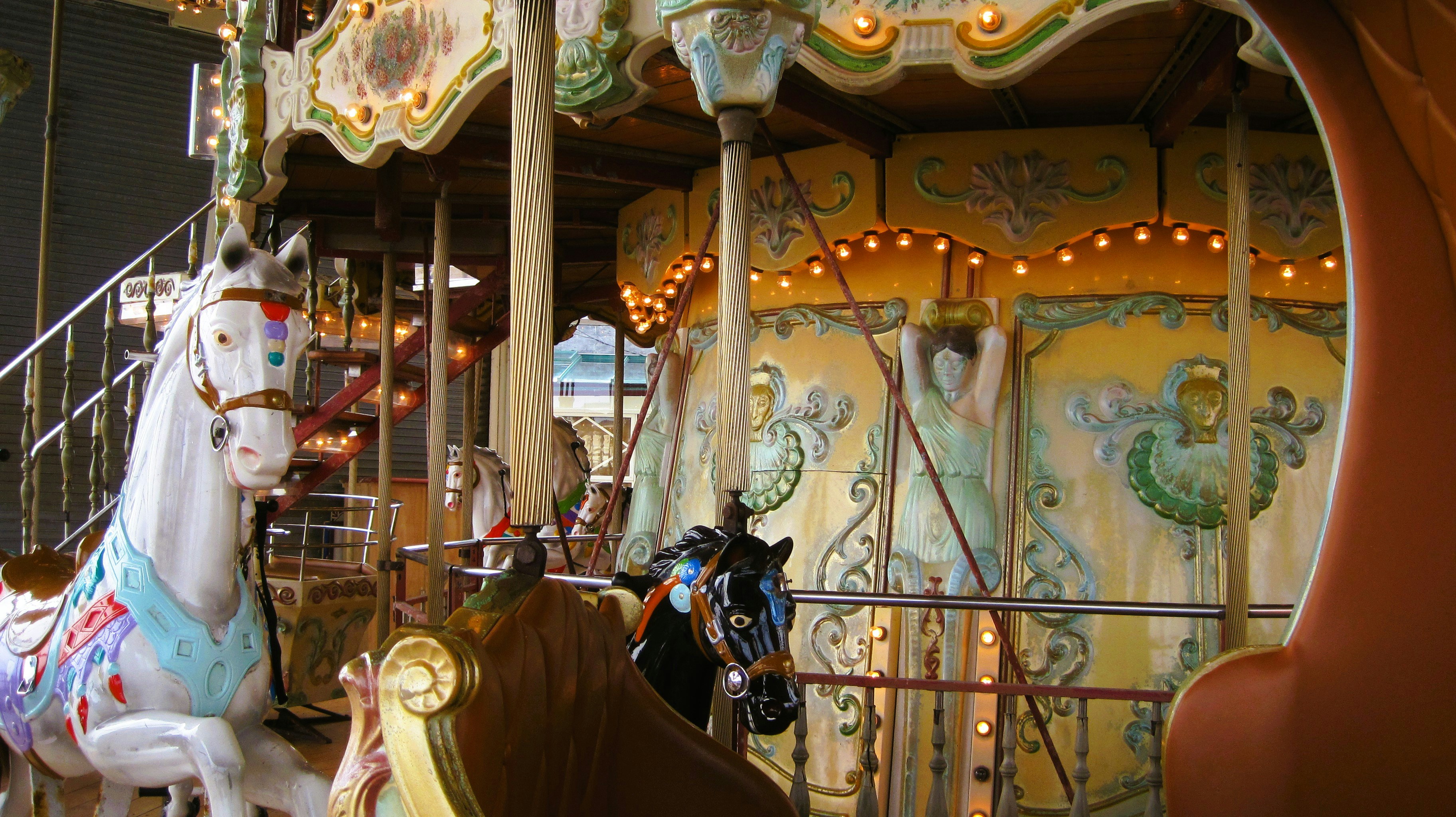 A merry go round at a carnival with horses