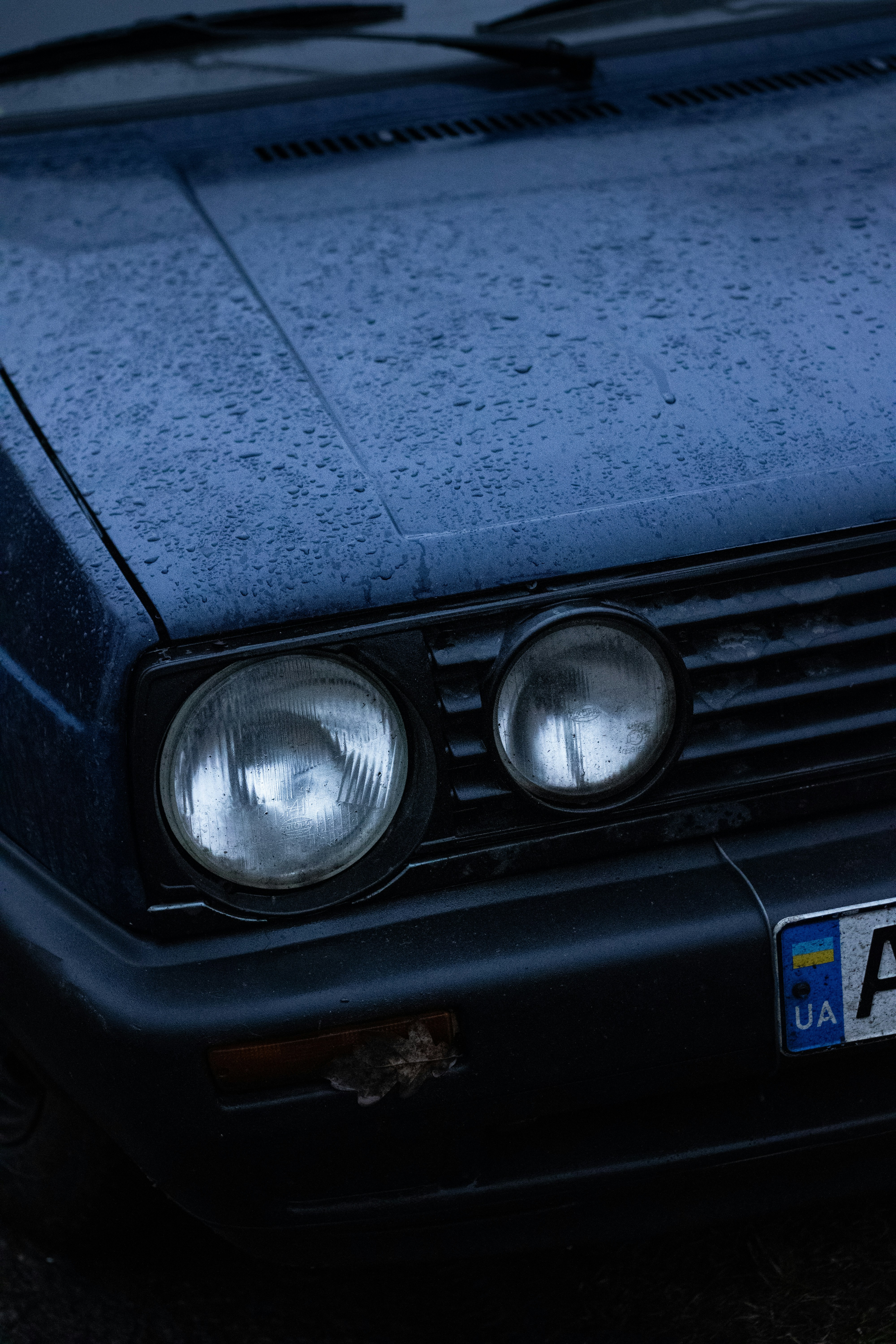 A blue car parked on the side of the road