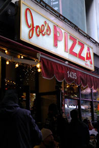 A restaurant with a sign that says joe's pizza
