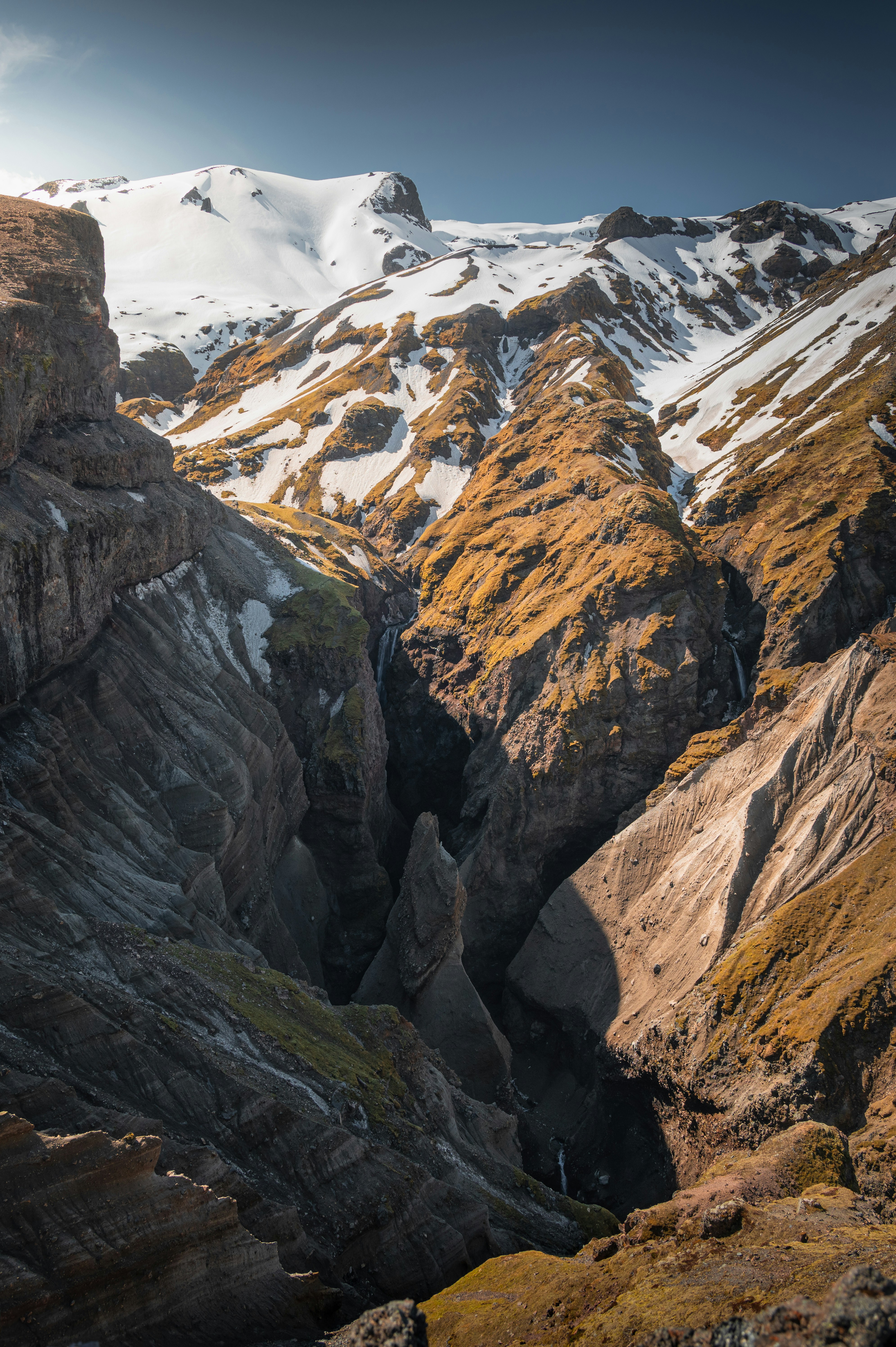 A mountain range with snow covered mountains in the background