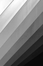 A black and white photo of a clock on the side of a building