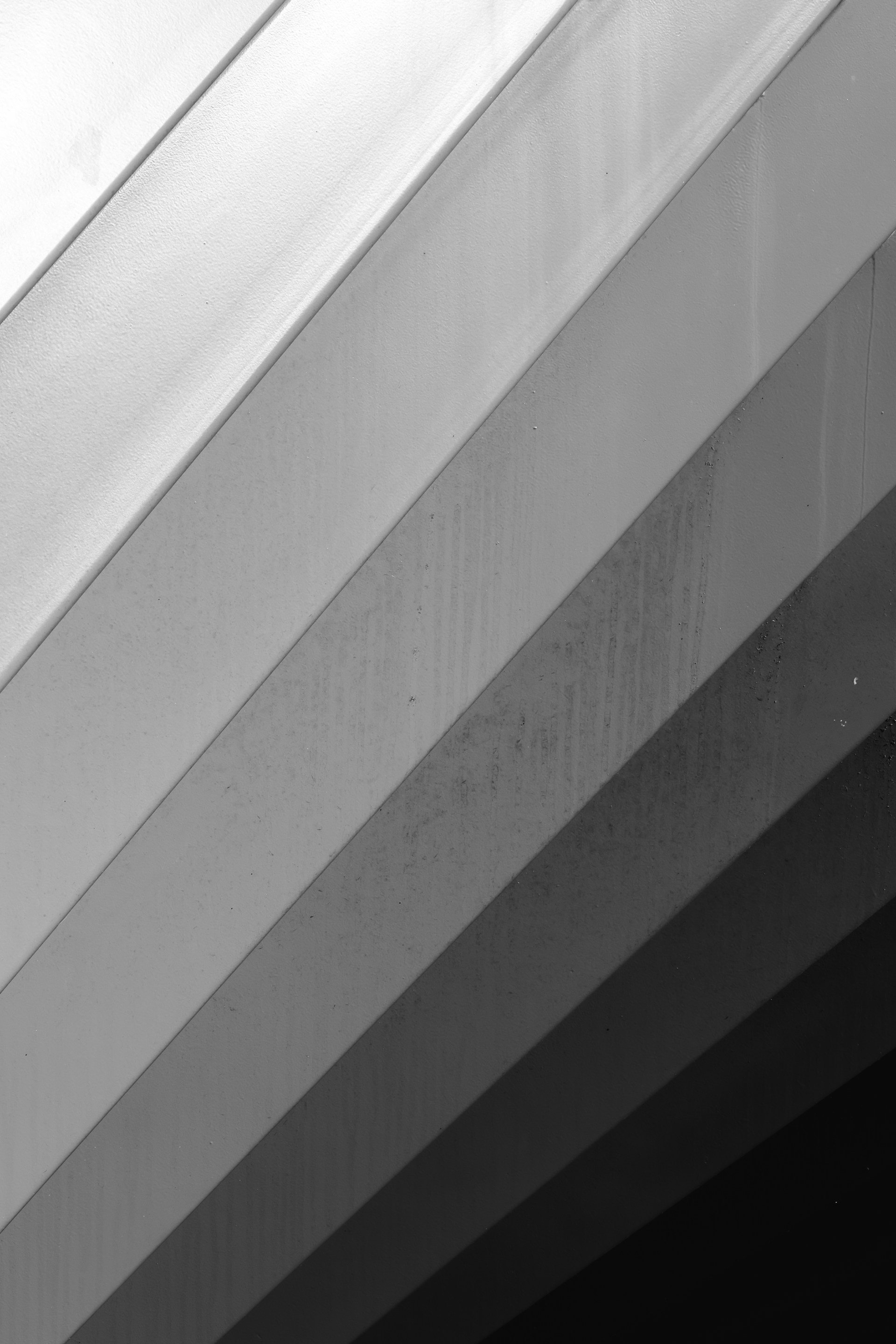 A black and white photo of a clock on the side of a building