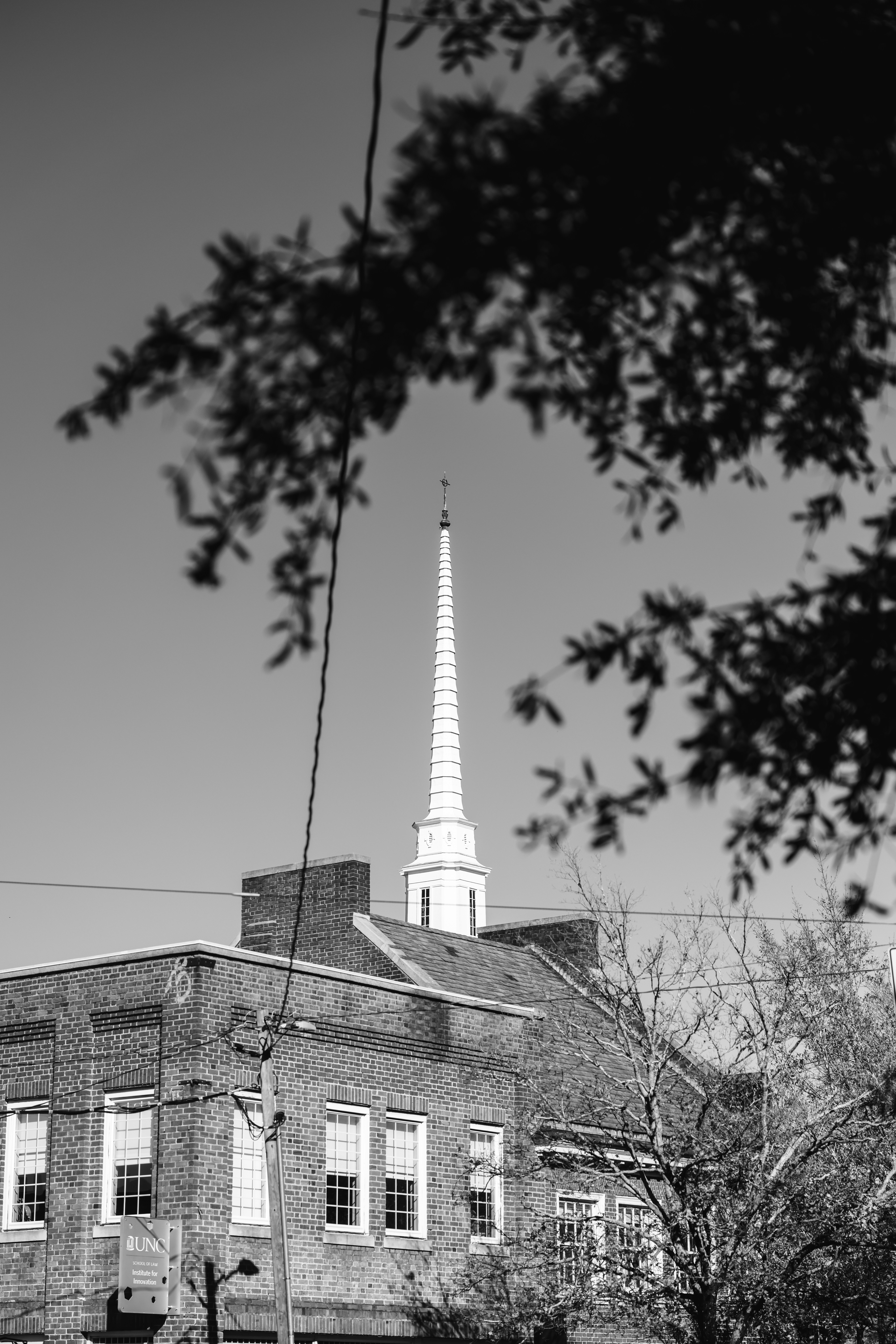 A black and white photo of a building with a steeple