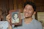 A man holding up a picture of a woman