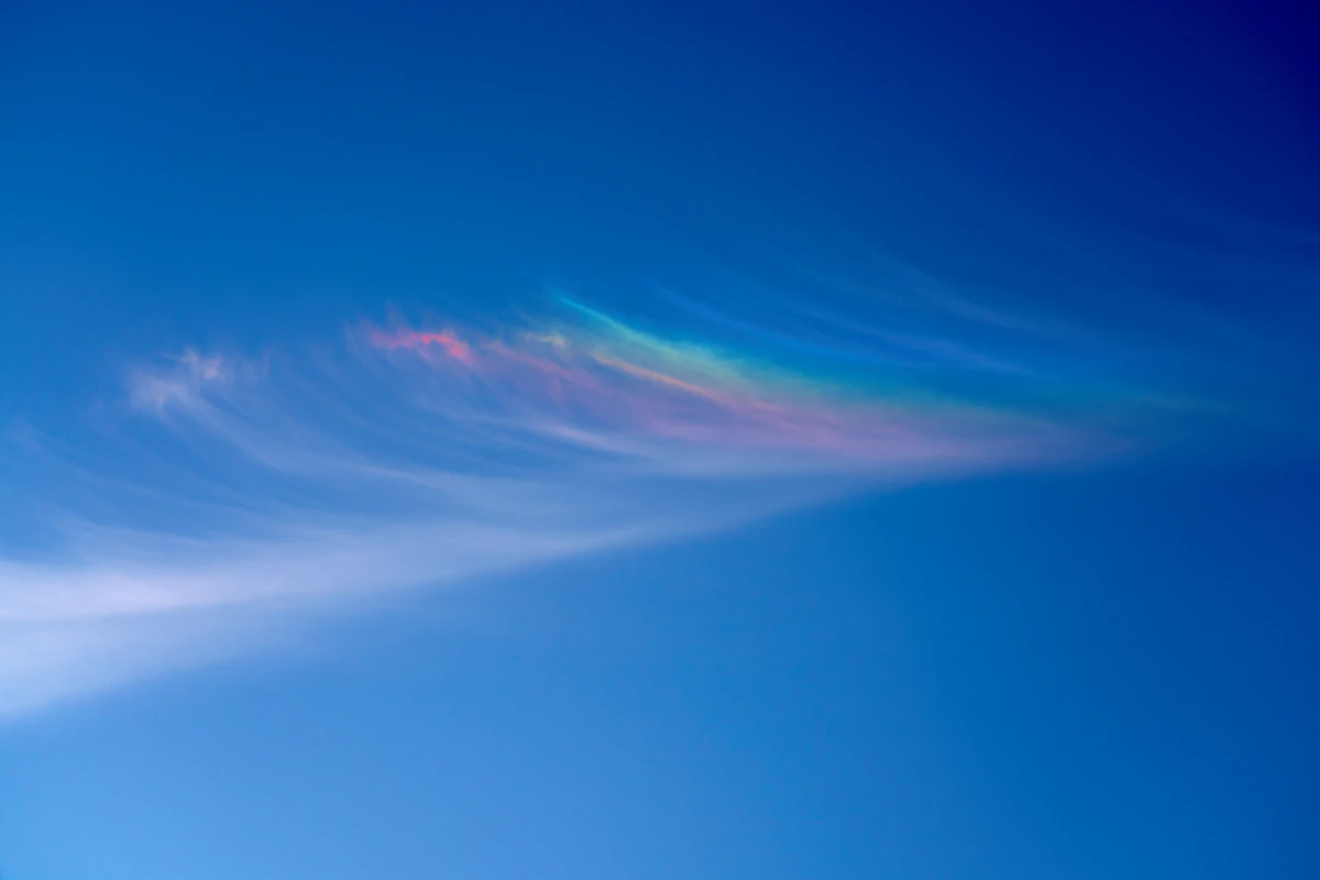 Rainbow arc across a blue sky