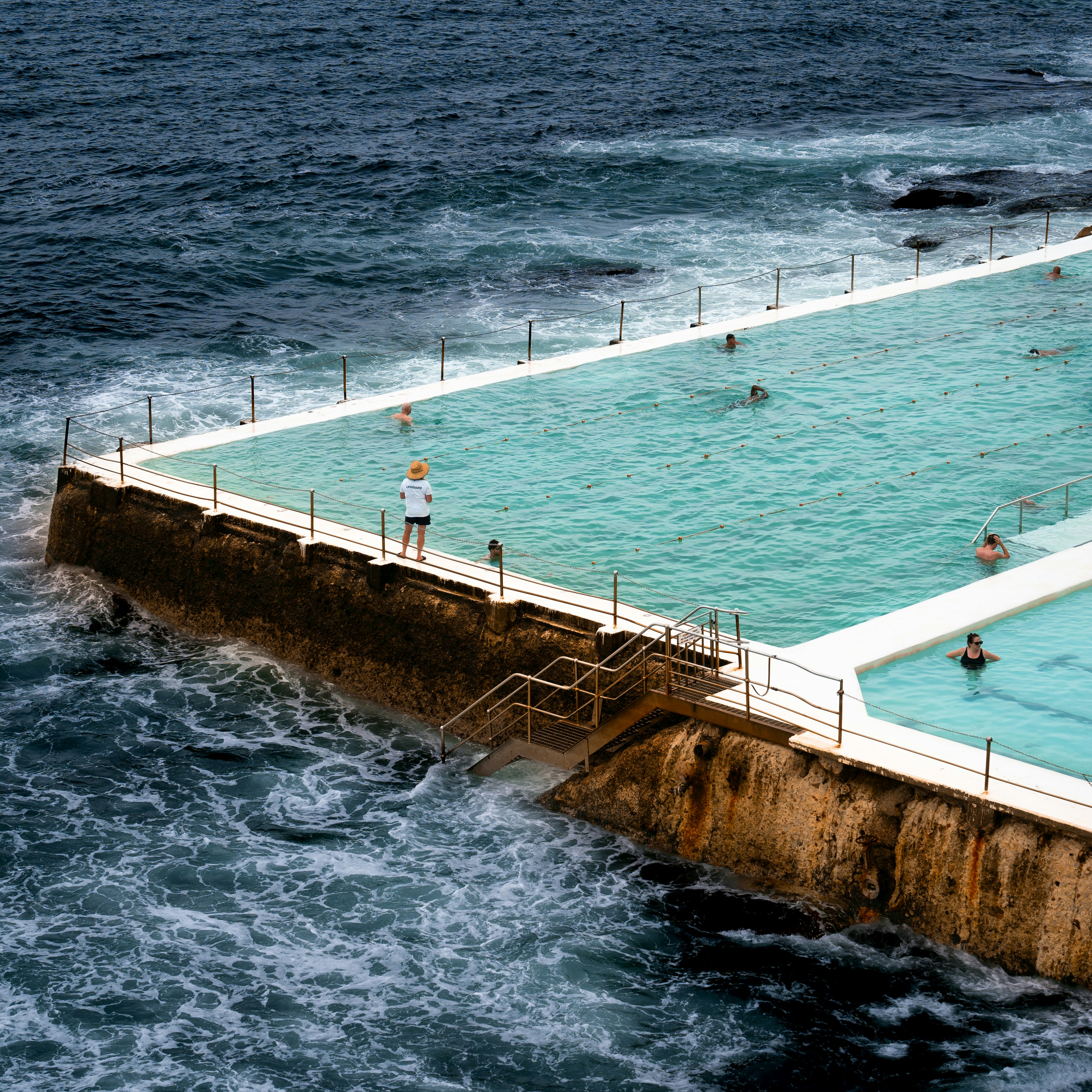 A large swimming pool in the middle of the ocean