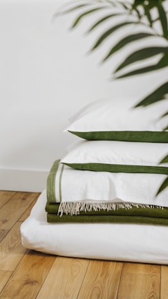 A stack of folded towels on a wooden floor