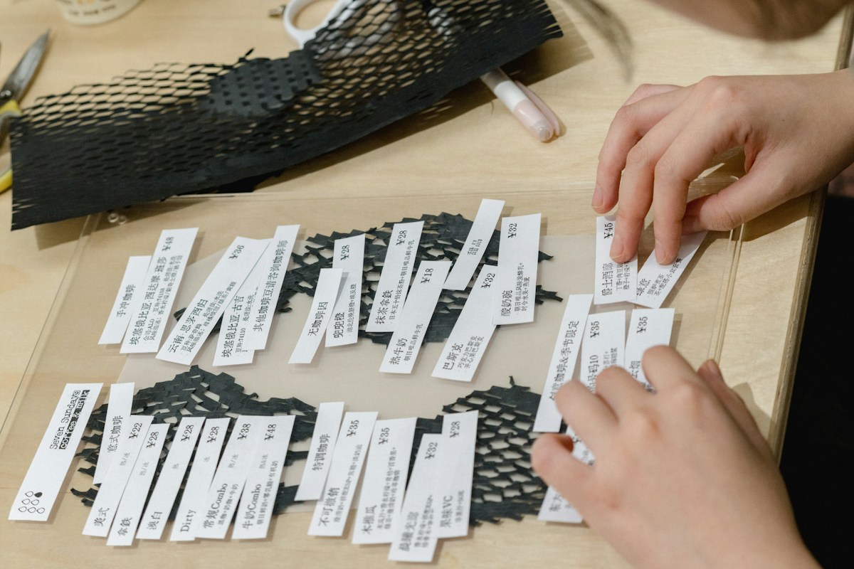 Person creating a paper pattern for a Sunday school craft project on a table with scissors and colored paper nearby