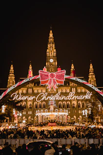 A large building with a christmas light display in front of it