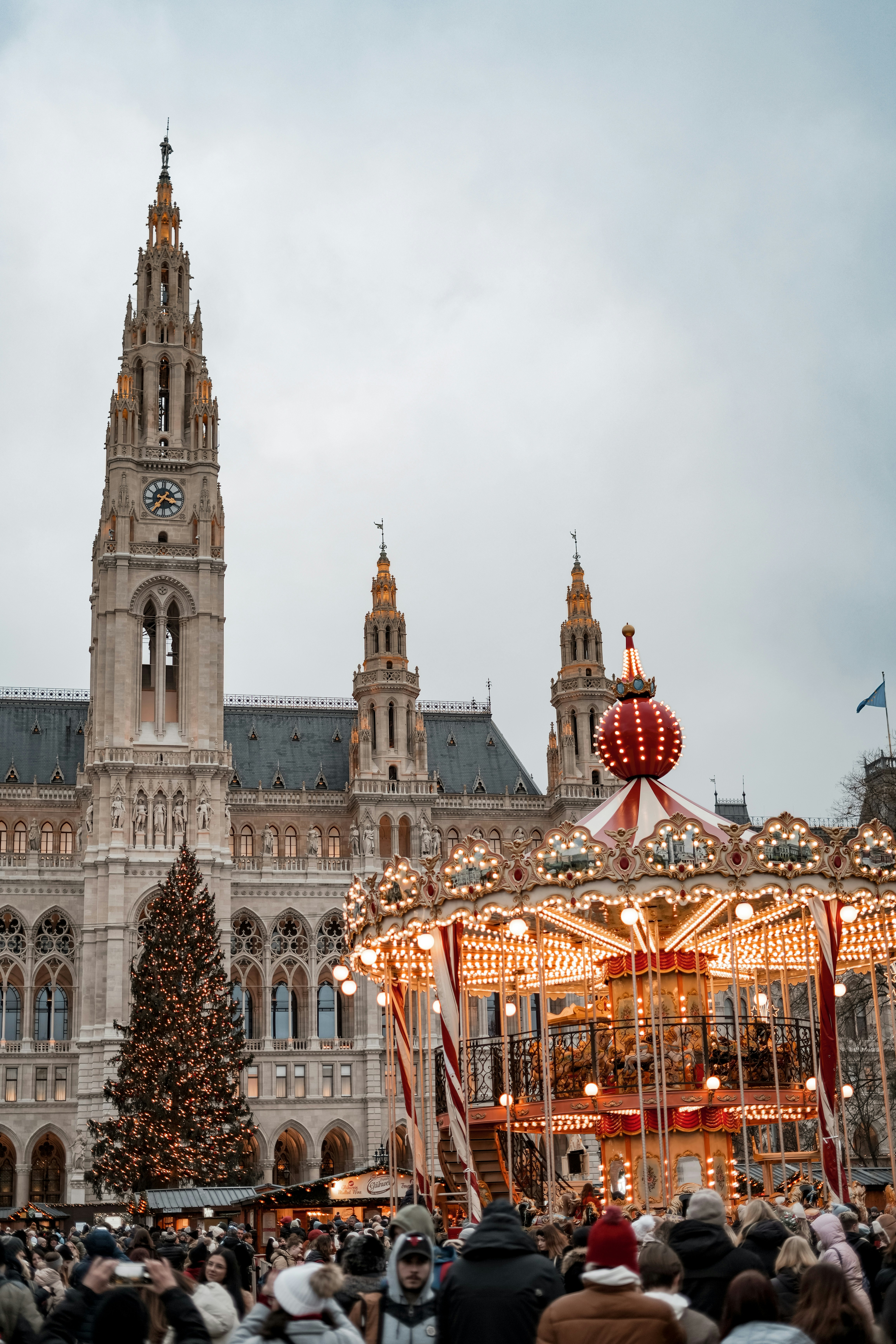 A large building with a christmas tree in front of it