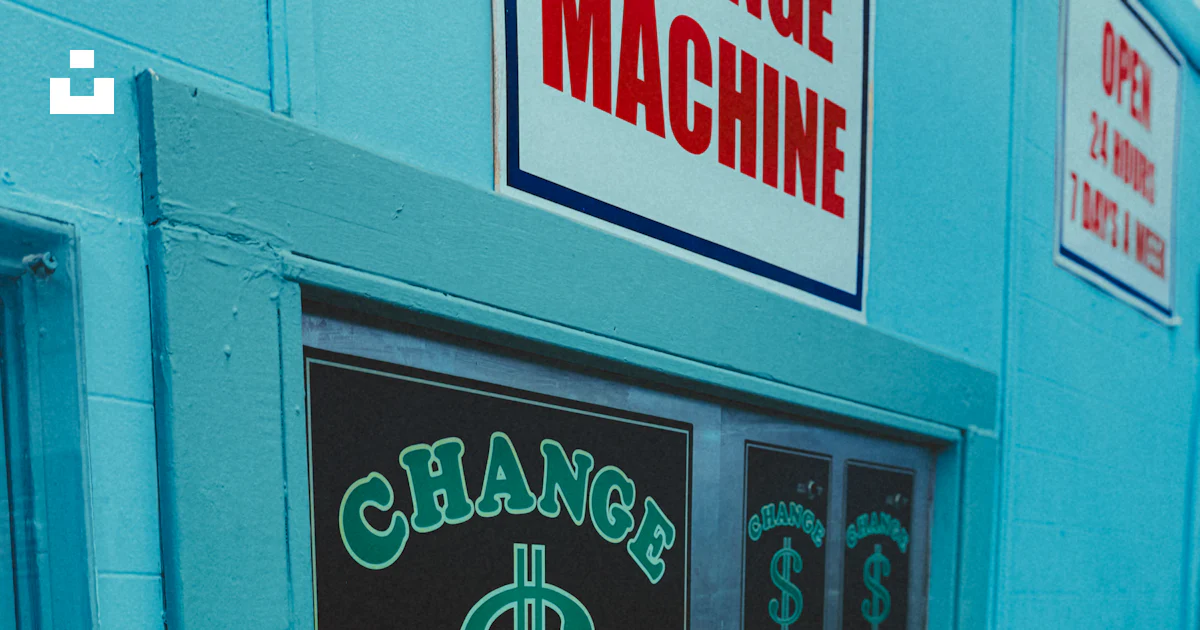 Changing Machine Sign A blue building with a sign that says change machine photo – Free ...