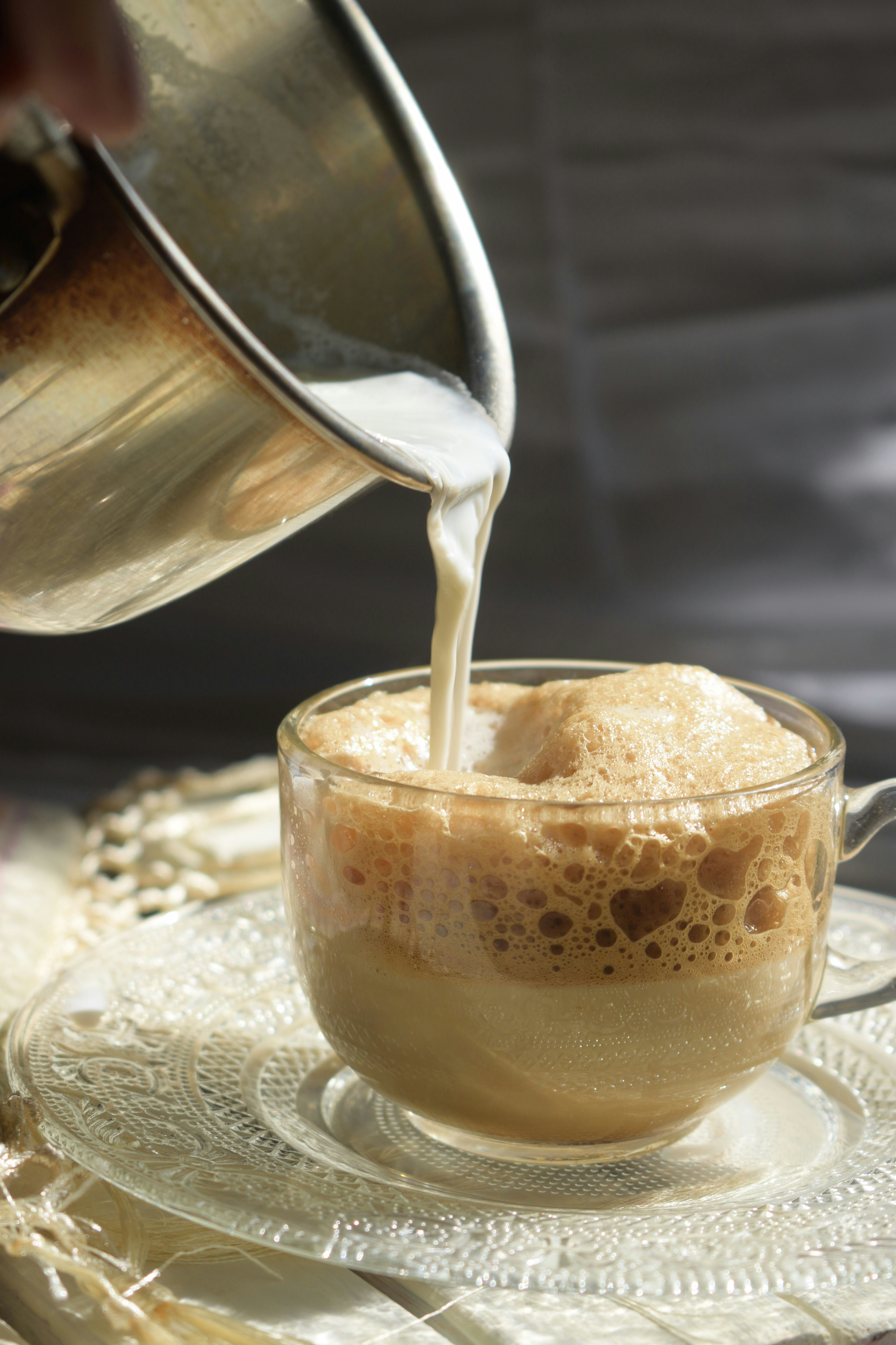 A person pours a cup of coffee