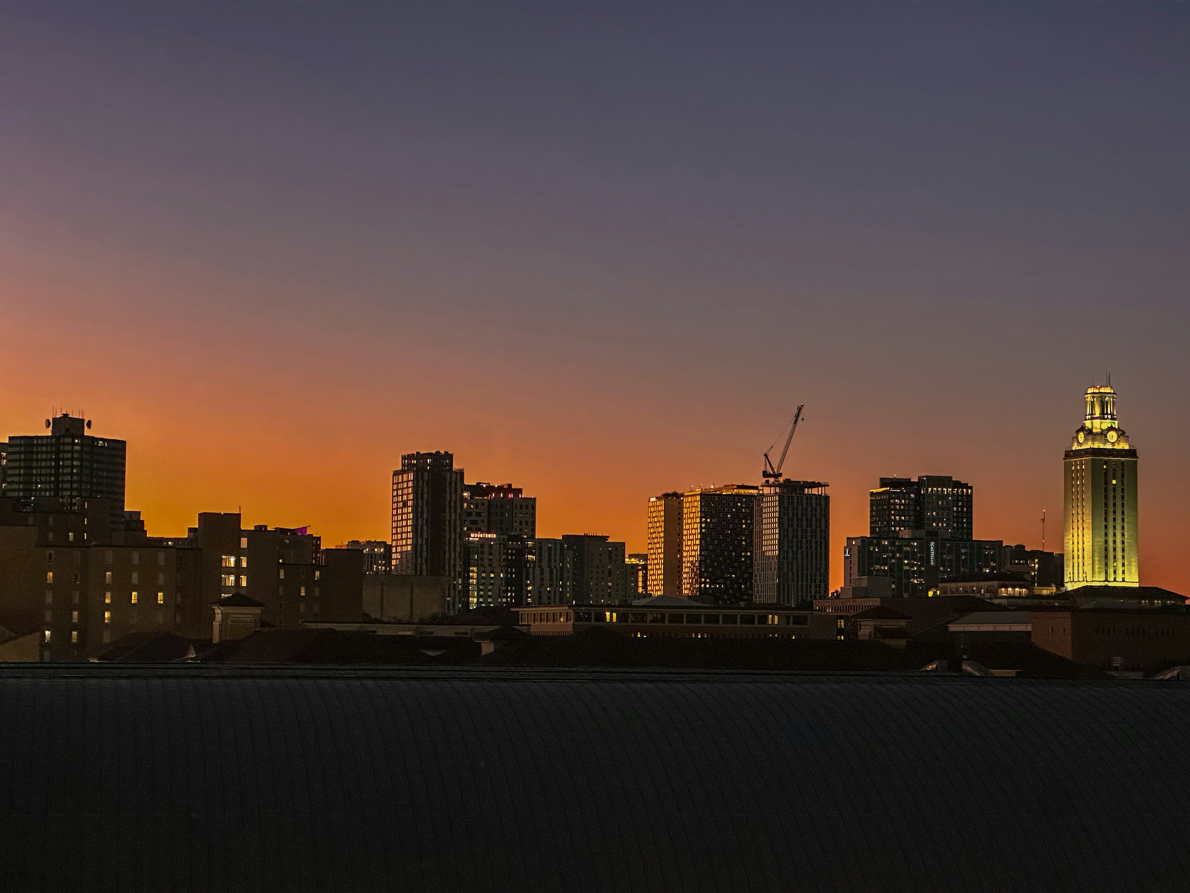 A view of a city skyline at sunset
