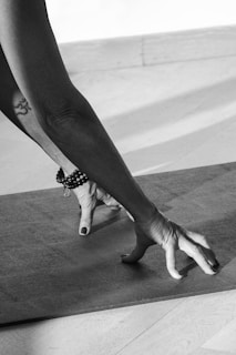 A black and white photo of a person doing yoga