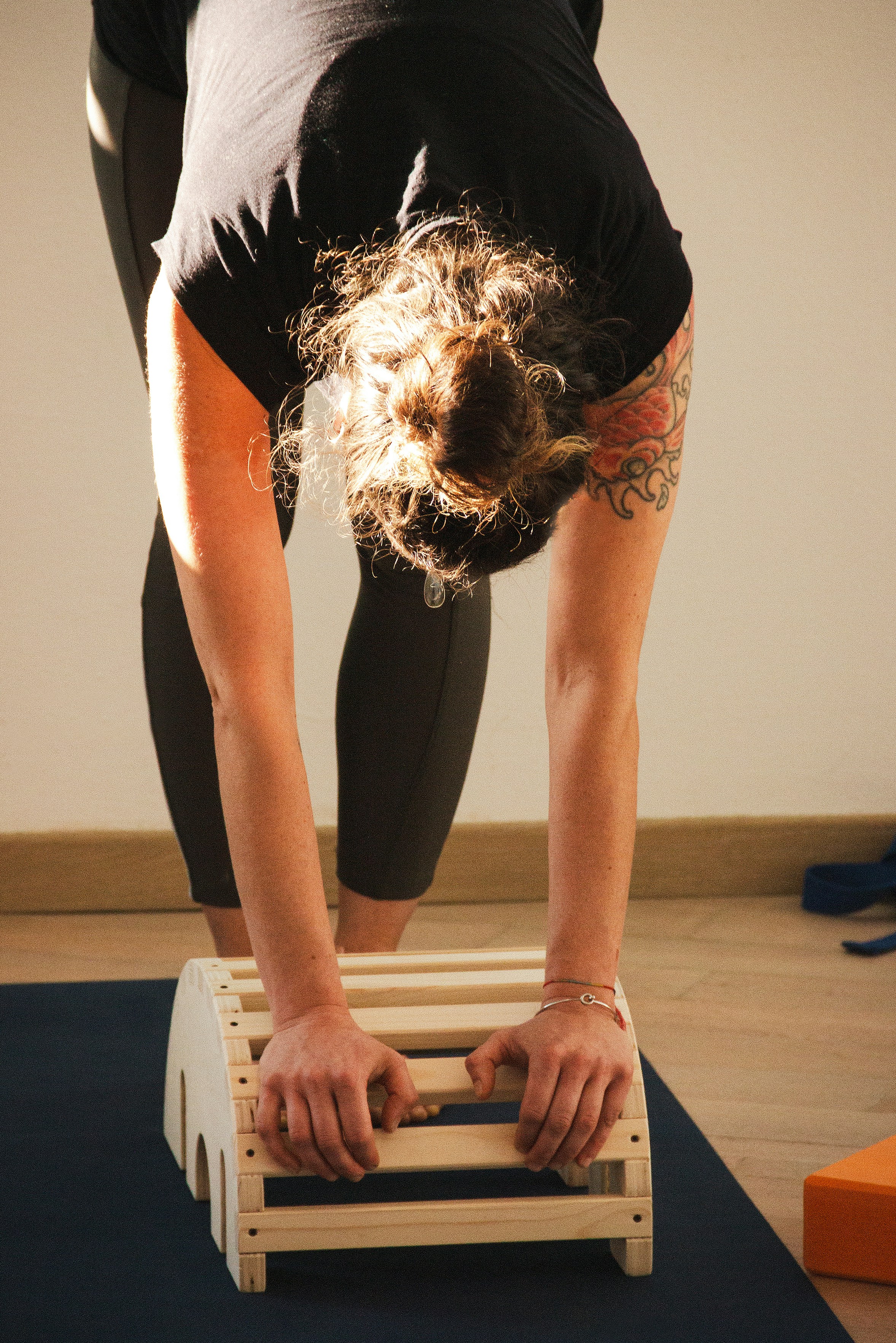 A woman doing a handstand on a yoga mat