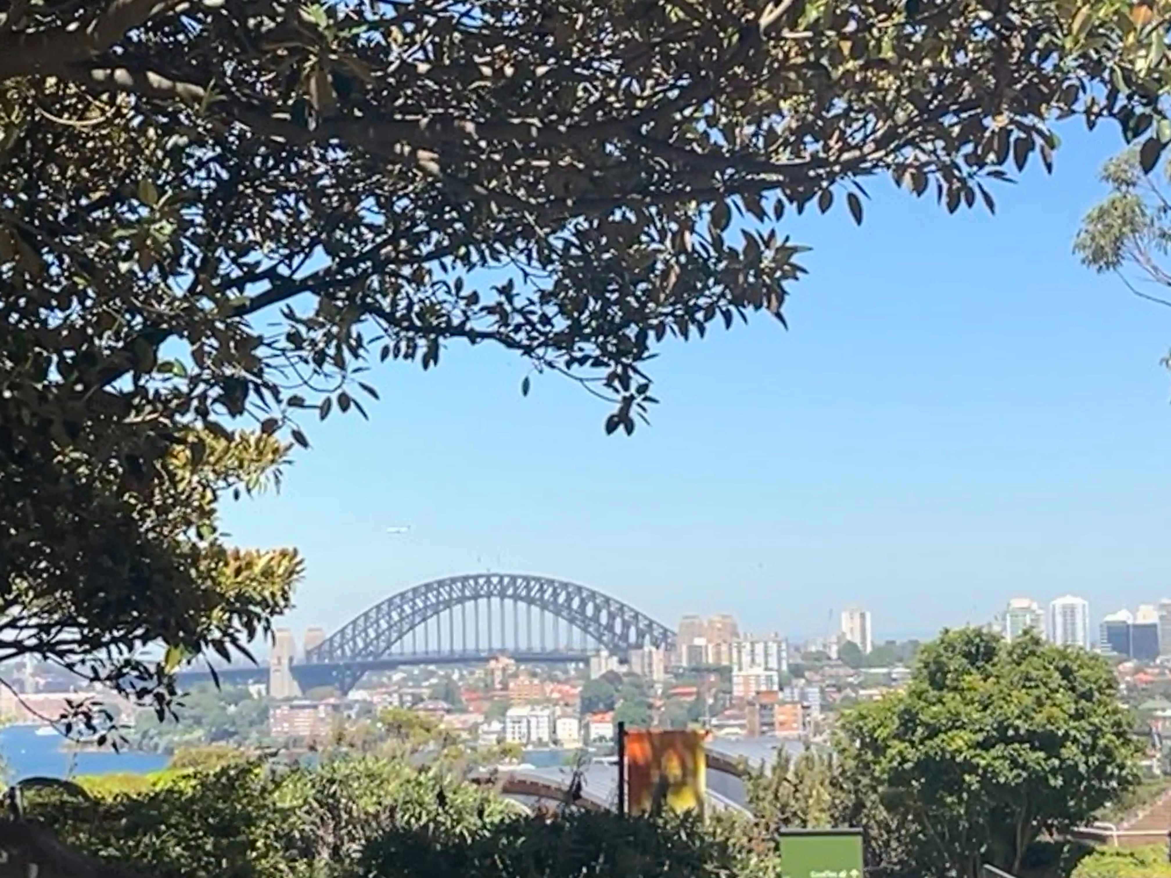 Sydney Harbour Bridge aerial view on bright sunny day, iconic Australian engineering landmark