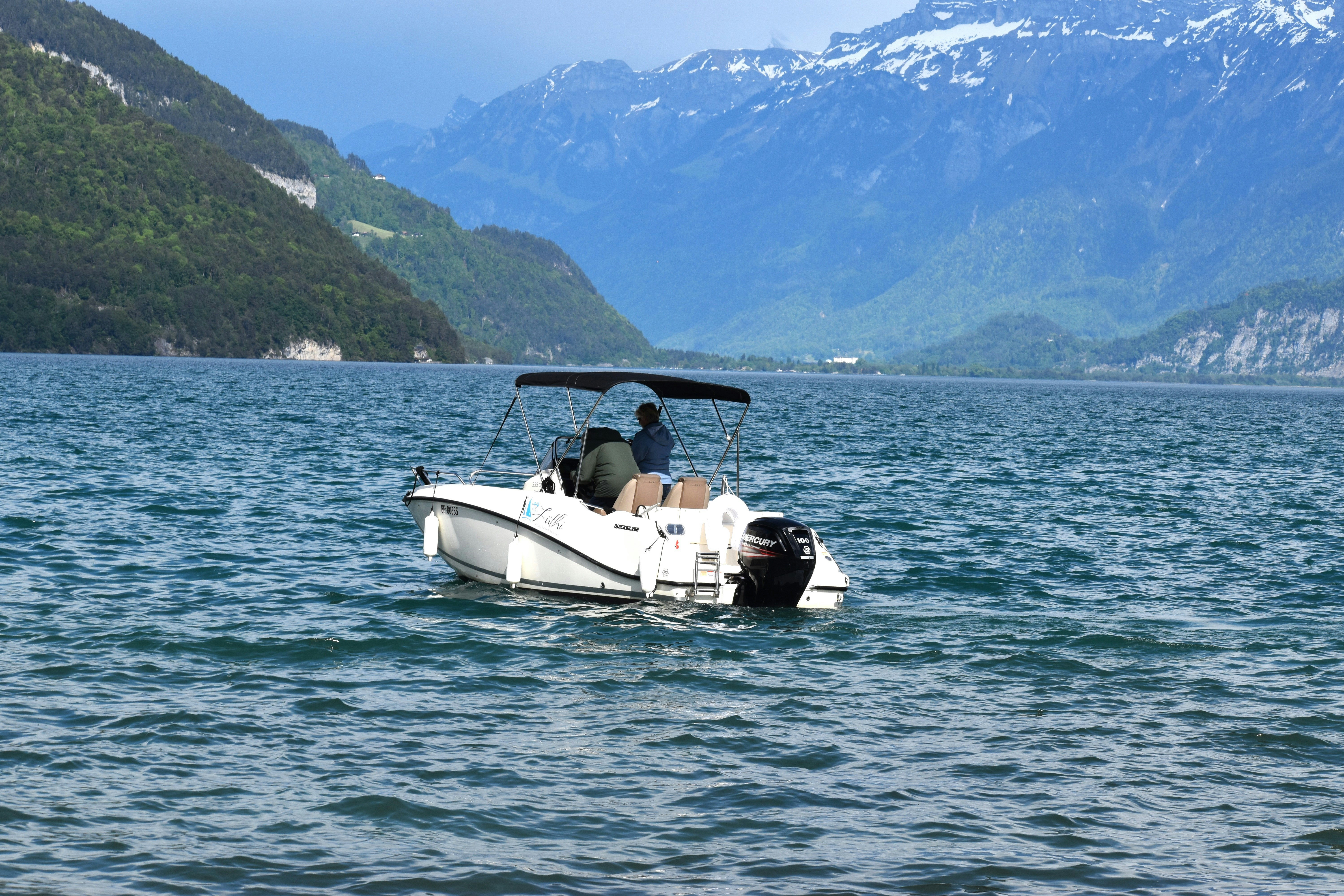 A small boat in the middle of a large body of water