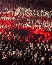 A large crowd of people standing around a stage