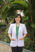 A woman standing in front of a palm tree
