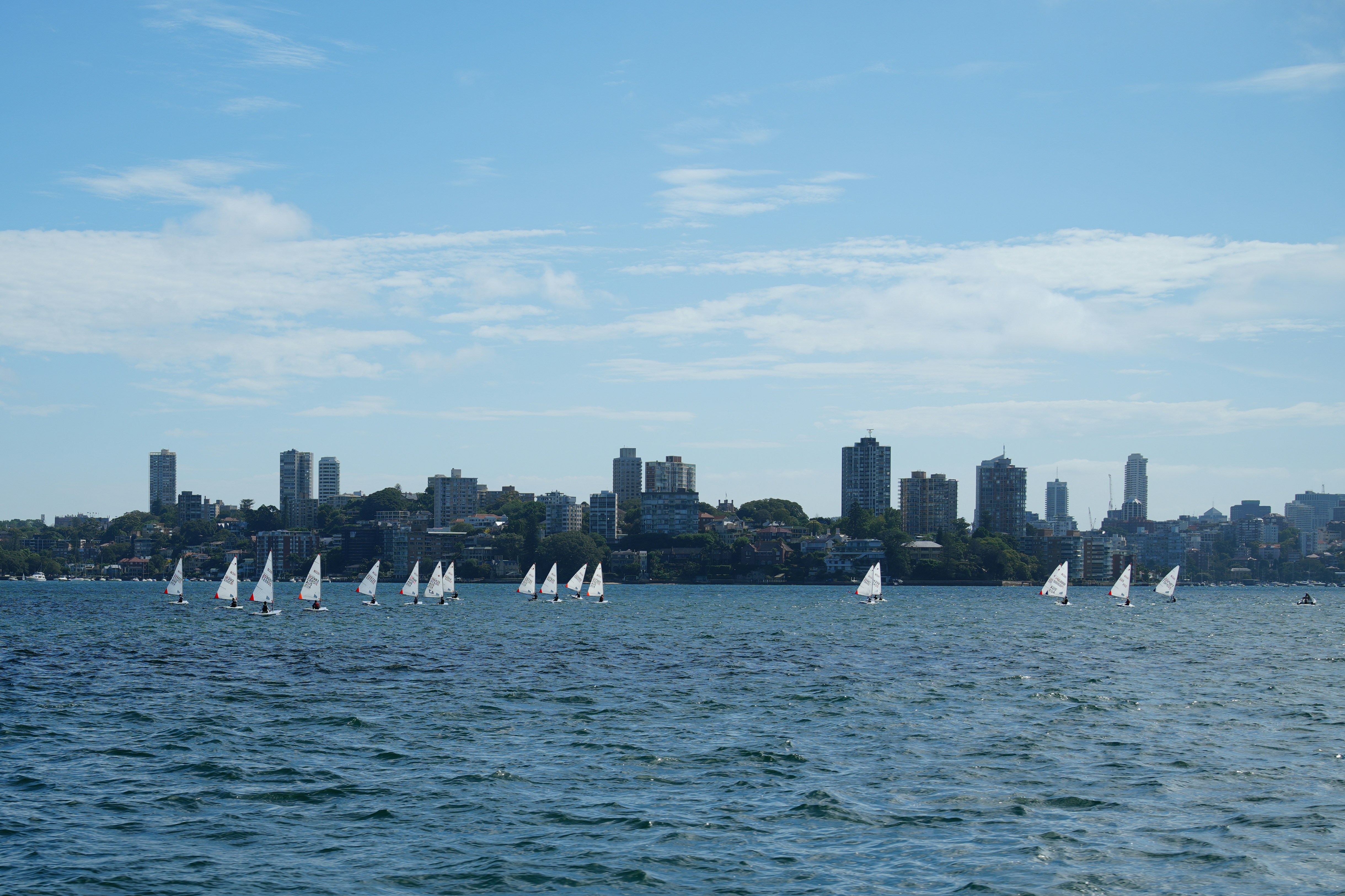 A large body of water with a city in the background
