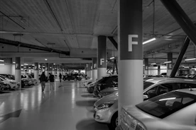A parking garage filled with lots of parked cars