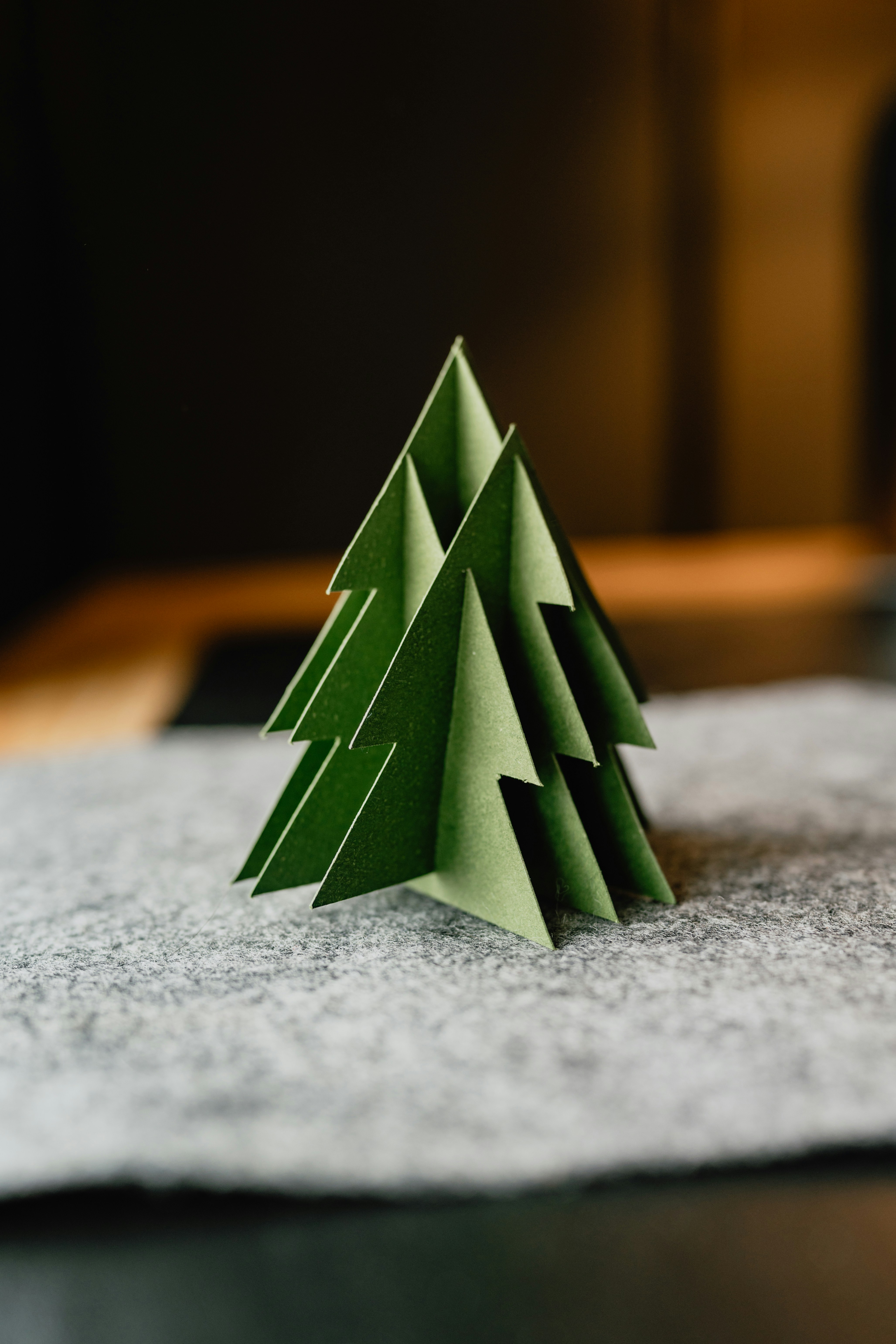 A paper christmas tree sitting on top of a table