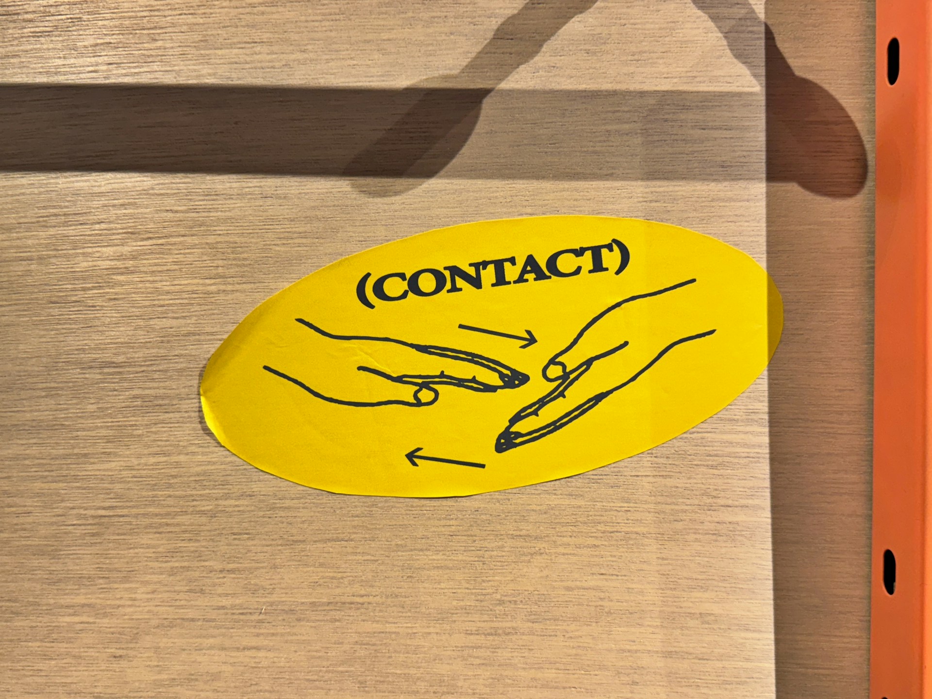 A yellow sticker that says contact on it