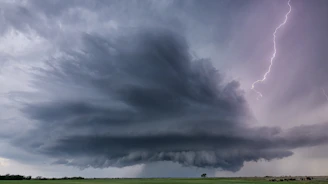 A storm is coming in over a green field