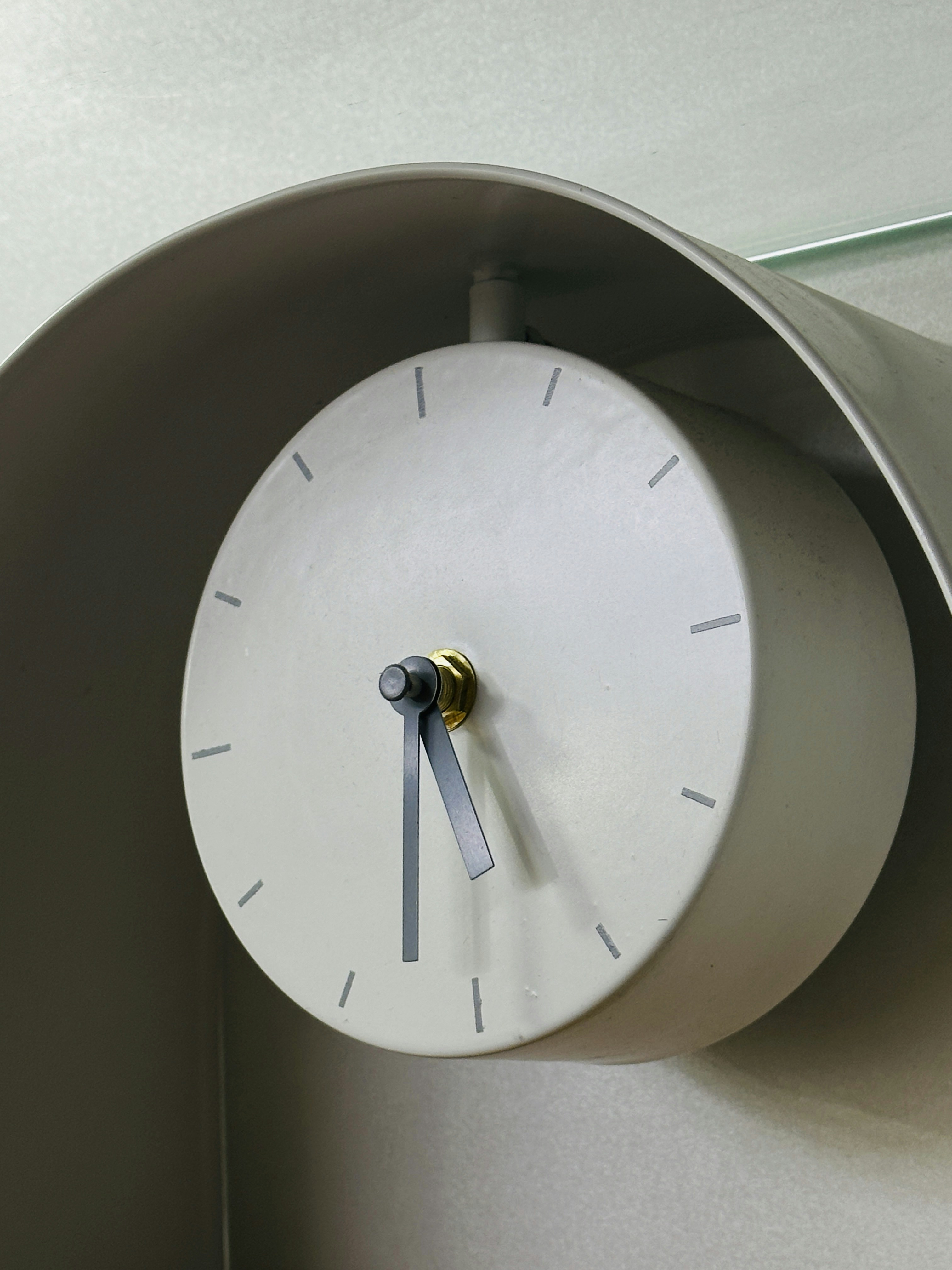 A clock on a wall with a glass top