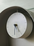 A clock on a wall with a glass top
