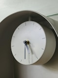 A clock on a wall with a glass top