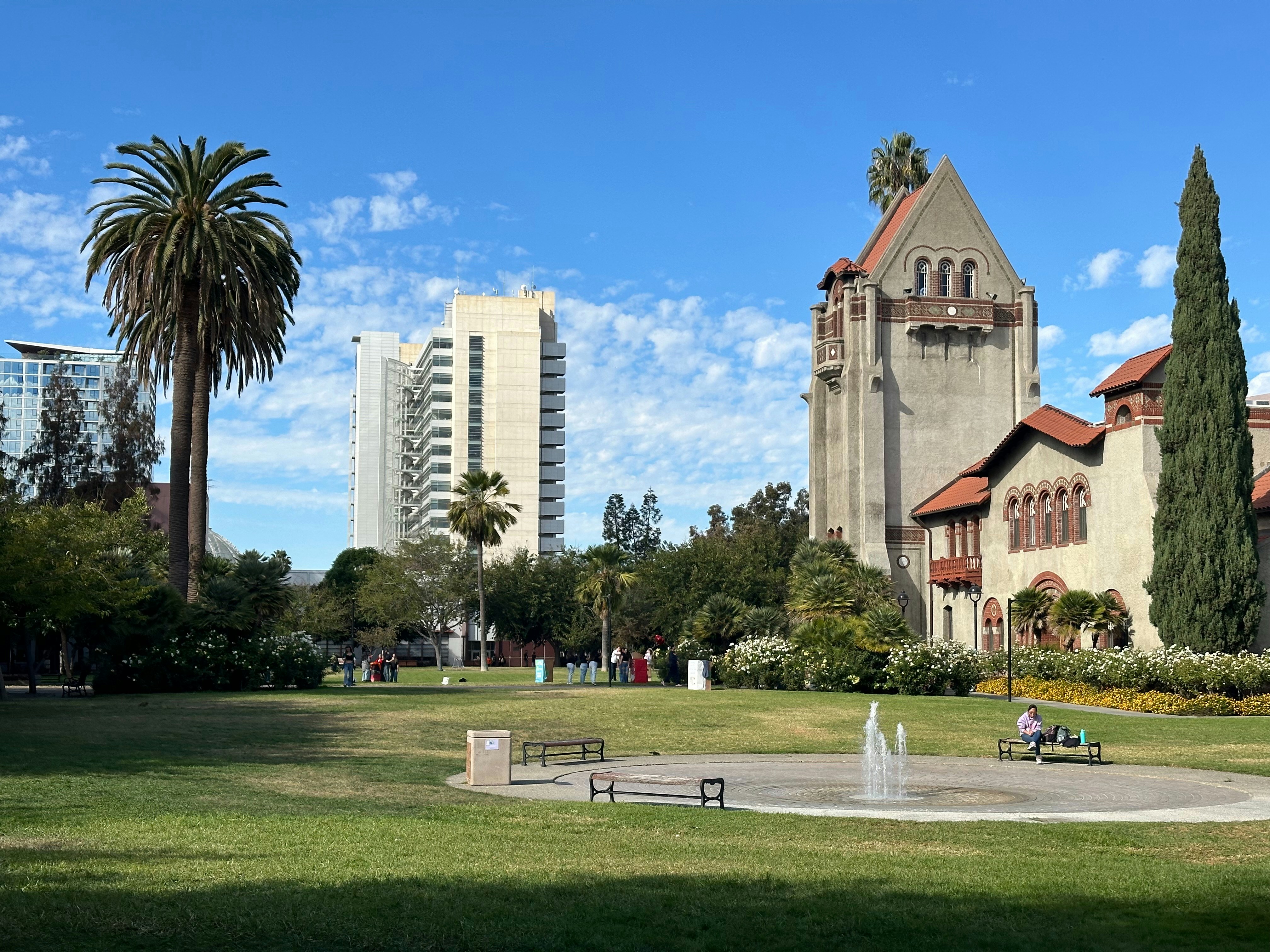 A large building with a fountain in front of it